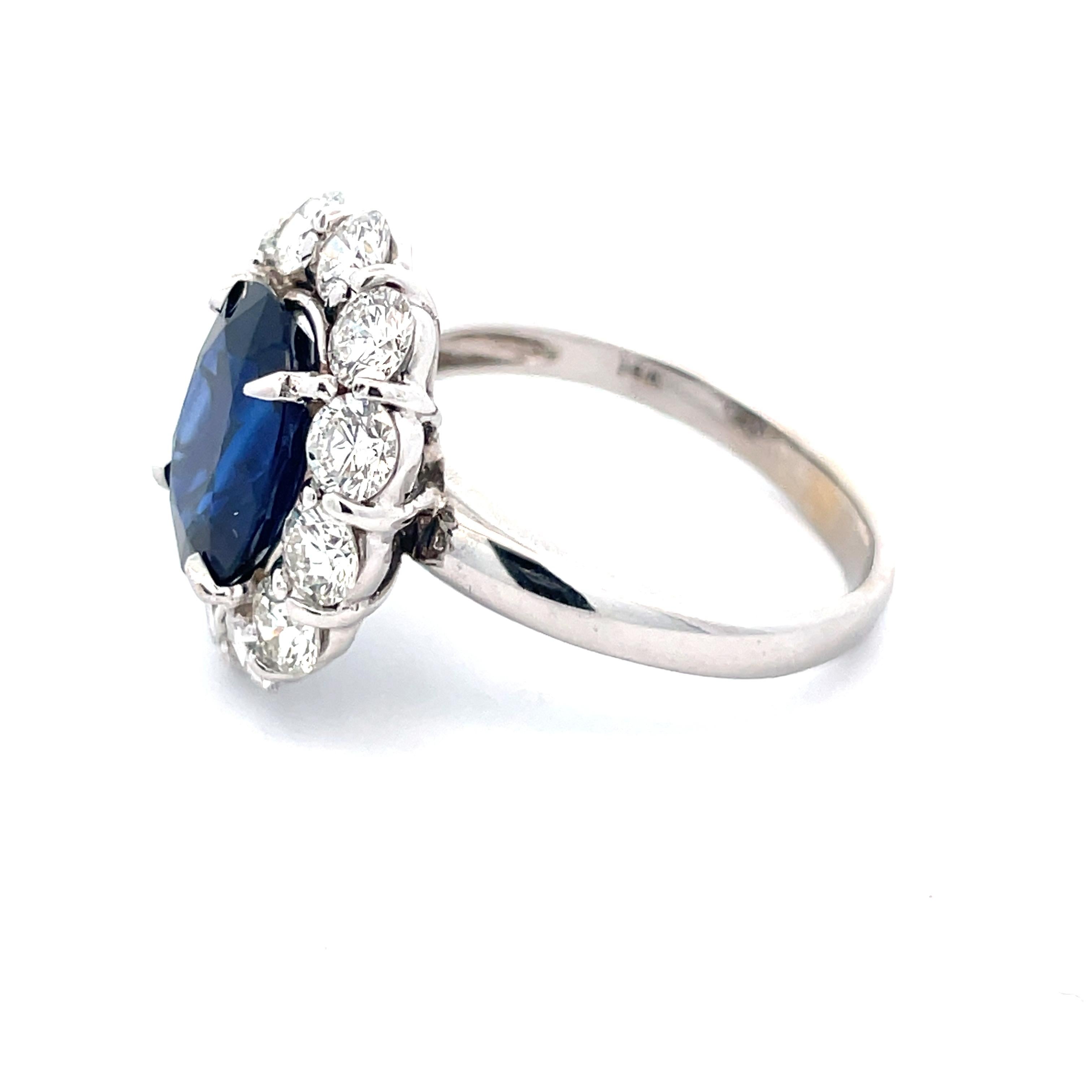 This 14k white gold Lady Di blue sapphire and diamond ring is a breathtaking, wearable piece of art. With 12 round cut, G/H color VS2 clarity diamonds totaling 2.16 tw, a white gold and a layered setting, this Lady Di ring naturally draws the eyes