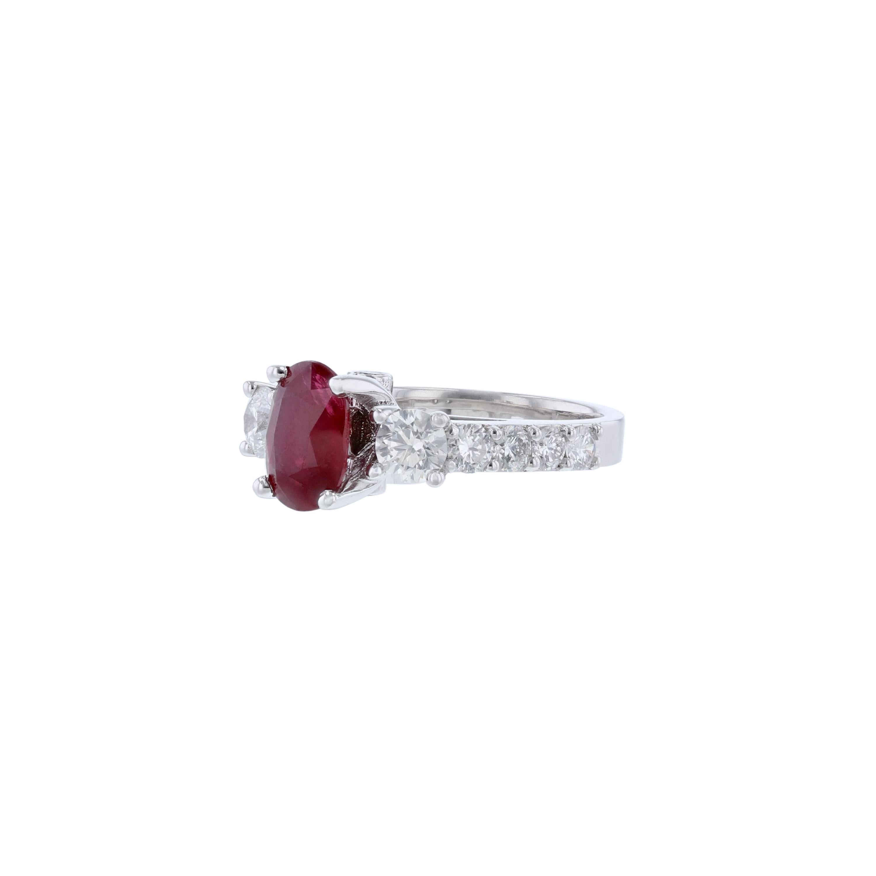 This ring is made in 14K white gold ring and features 1 oval shape natural corundum (no heat) ruby weighing 1.46 carats. As well as 12 round cut diamonds weighing 0.55 carat. With a color grade (H) and clarity grade (SI2)