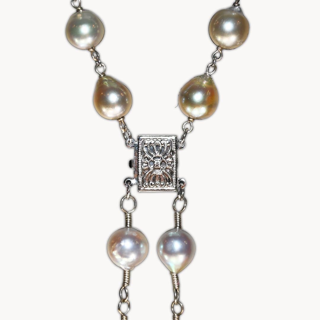 Cultured pearl clear quartz necklace with 14k white gold clasp and wire.
The pearls are off-round and range in size from 7.5mm to 8mm.
The large pearl pendant is 10.5mm pearl shape. The luster is very good.
The body color is silver with light green