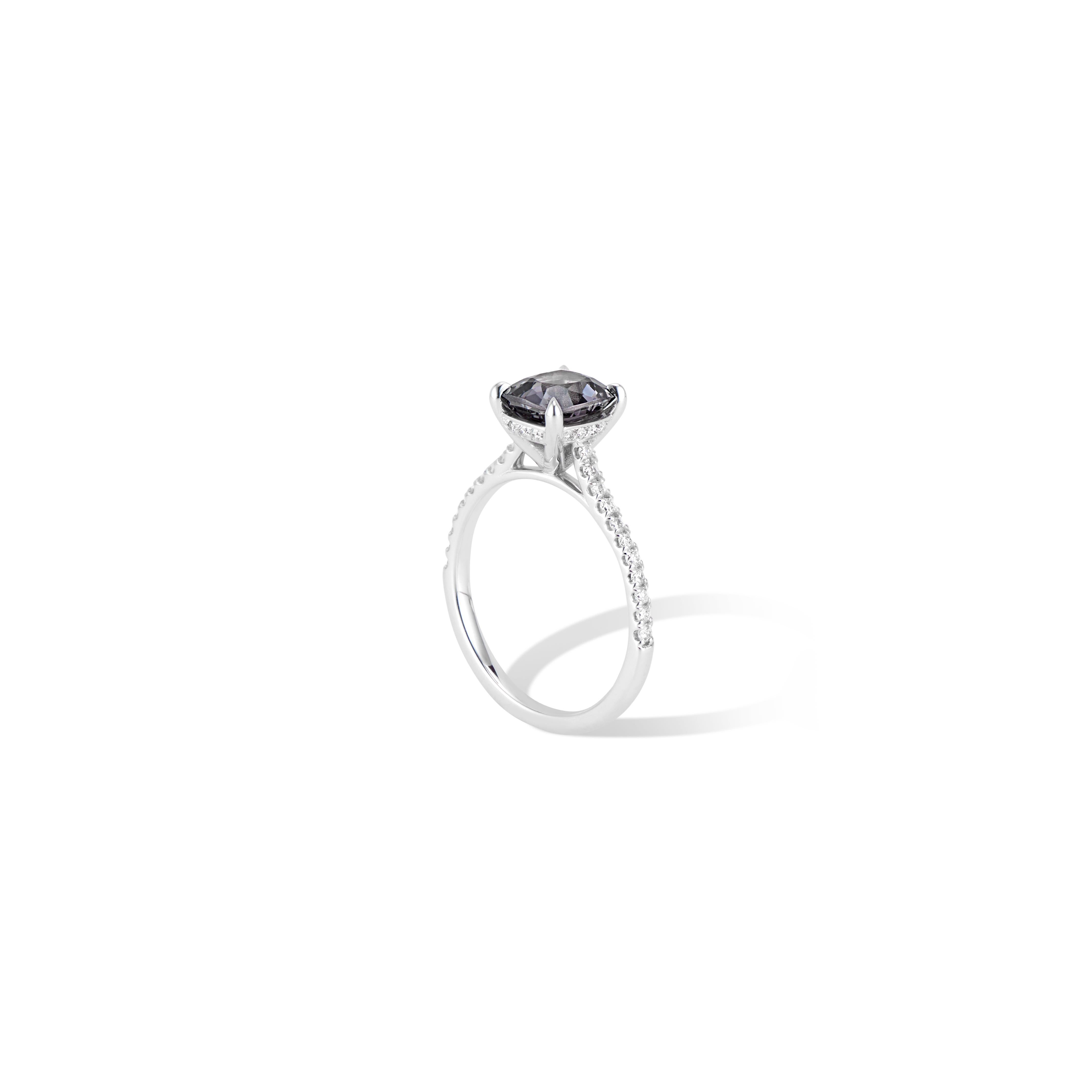 A beautiful 1.51 cwt. natural grey spinel set in an elegant claw setting with a hidden diamond halo, on a band accented with VS quality round brilliant diamonds.
It’s all in the details with this unique Spinel ring.

Spinel is generally highly