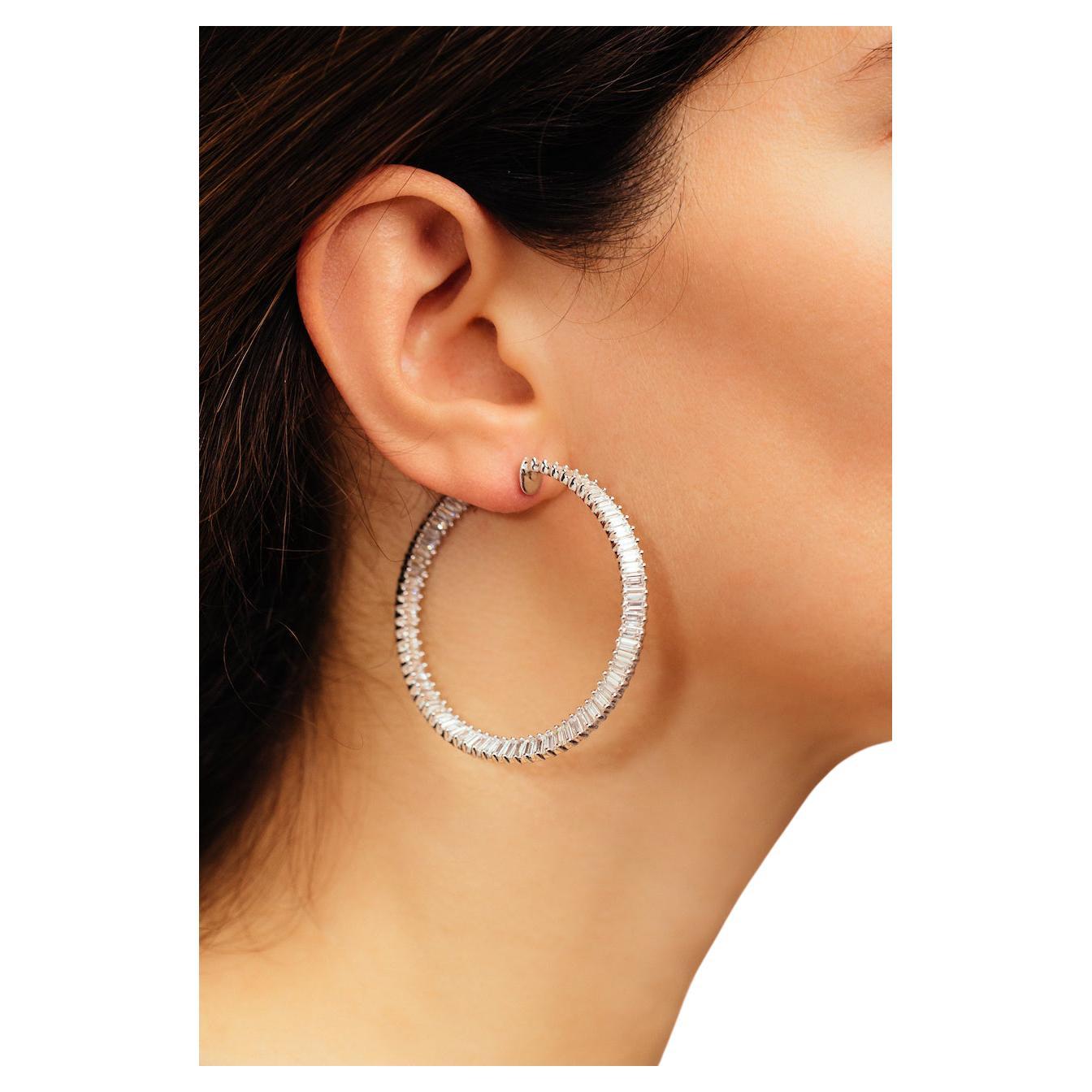 Twisting Hoops with a Dancing wave of Baguettes. Captivating and distinct-like the flamenco itself-these baguette diamond hoops hold a unique, twisting torque. As a result, the stones flash and flicker when viewed from any angle (especially when