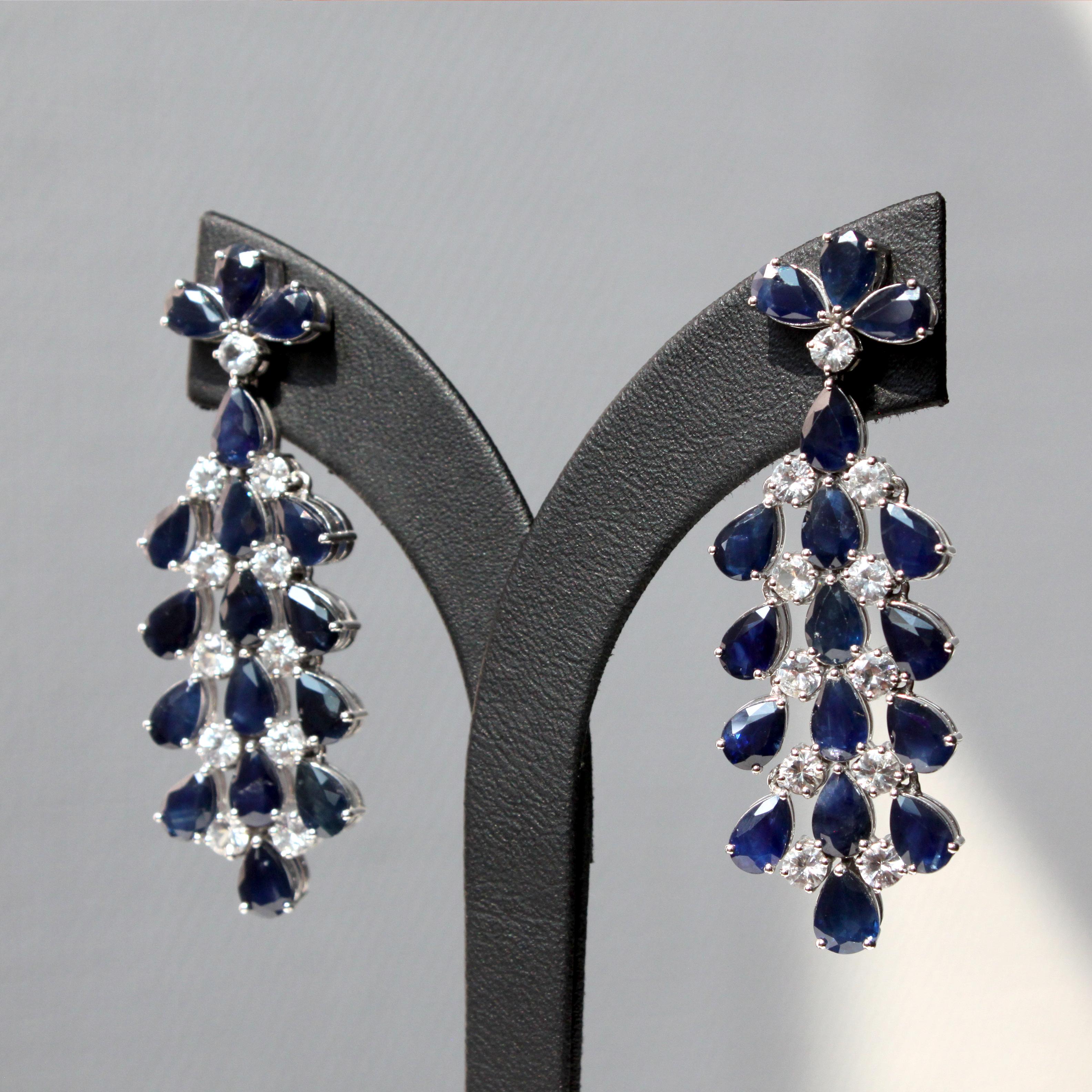 14K white gold
16.36ct blue sapphire 
2.65ct white sapphire 
Total earring weight 18.8g

These mesmerizing earrings showcase a vibrant cascade of blue sapphires, totaling approximately 16.36 carats, set in glistening 14K white gold. Seventeen