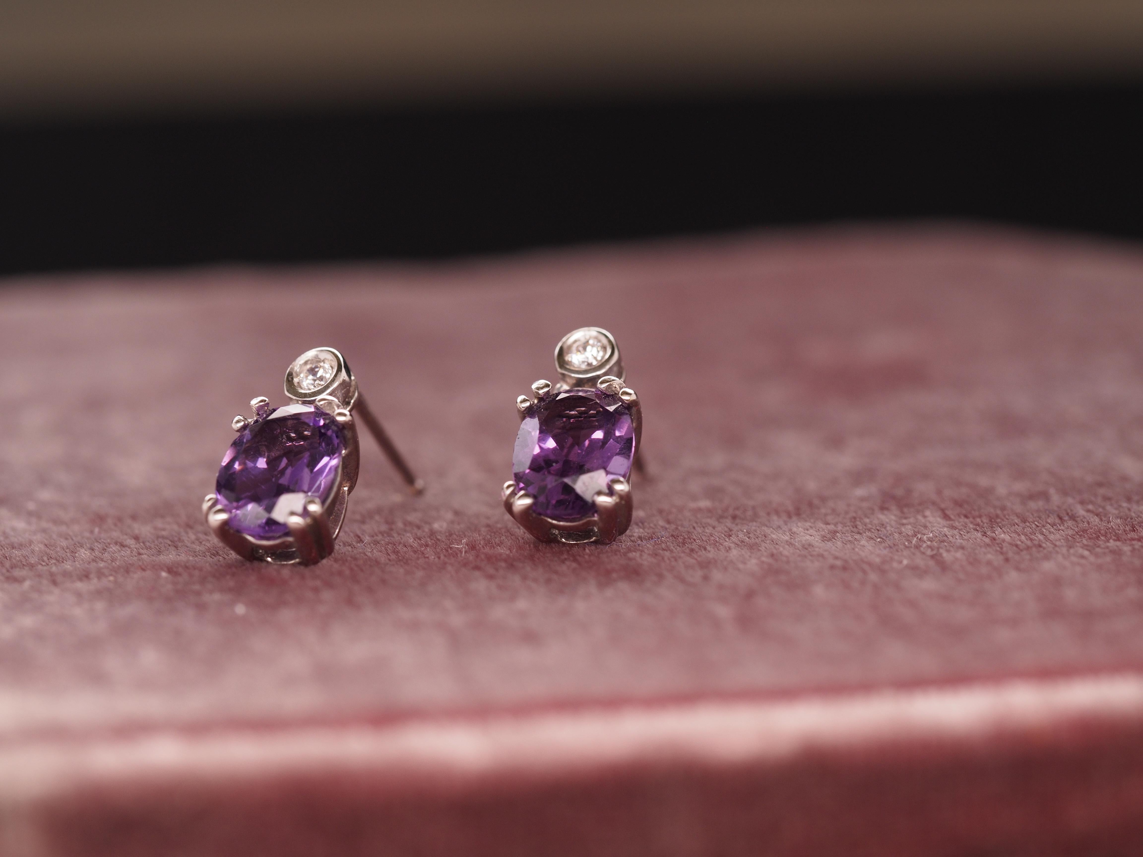 Item Details:
Metal Type: 14K White Gold   [Hallmarked, and Tested]
Weight:  2.4 grams

Diamond Details:

Type: Natural
Weight: .05ct, total weight
Cut: Round brilliant
Color: G-H
Clarity: VS

Amethyst Details:
Weight: 1 Carat each
Cut: Oval
Color:
