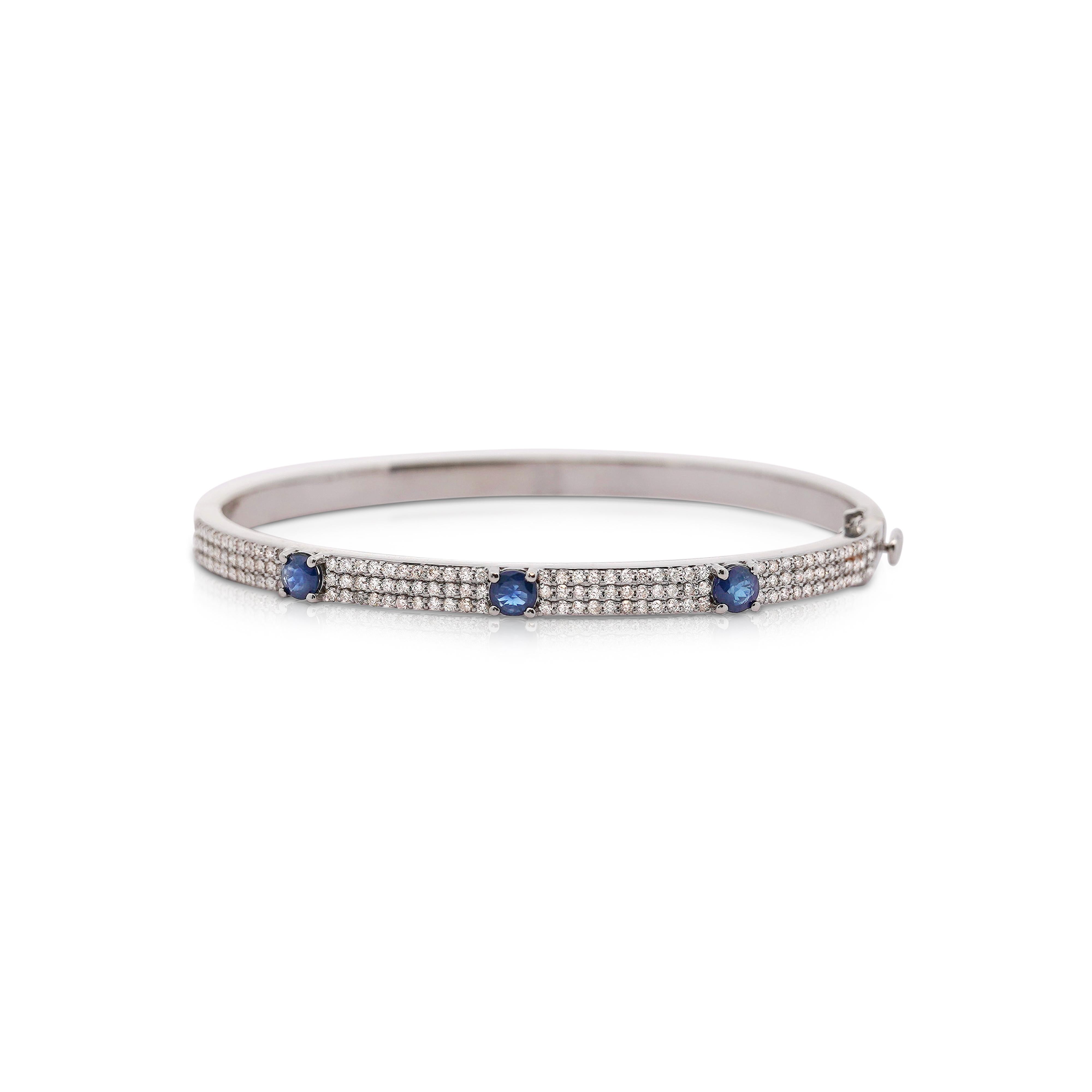 2.20 carat total blue sapphire and white diamond bangle bracelet in 14k white gold. 2.5 inch diameter (fits 7.8