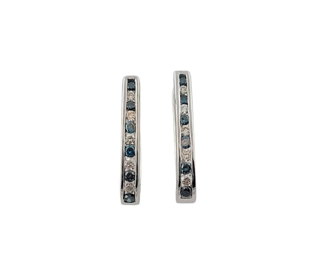 These beautiful gold, diamond and blue topaz earrings are the perfect accessory for any outfit.

The earrings hang approx 18 mm.

10 round brilliant diamonds (5 per earring), approx. .45 - .50 cwt., 

SI - I Clarity.

H - I Color

12 genuine blue