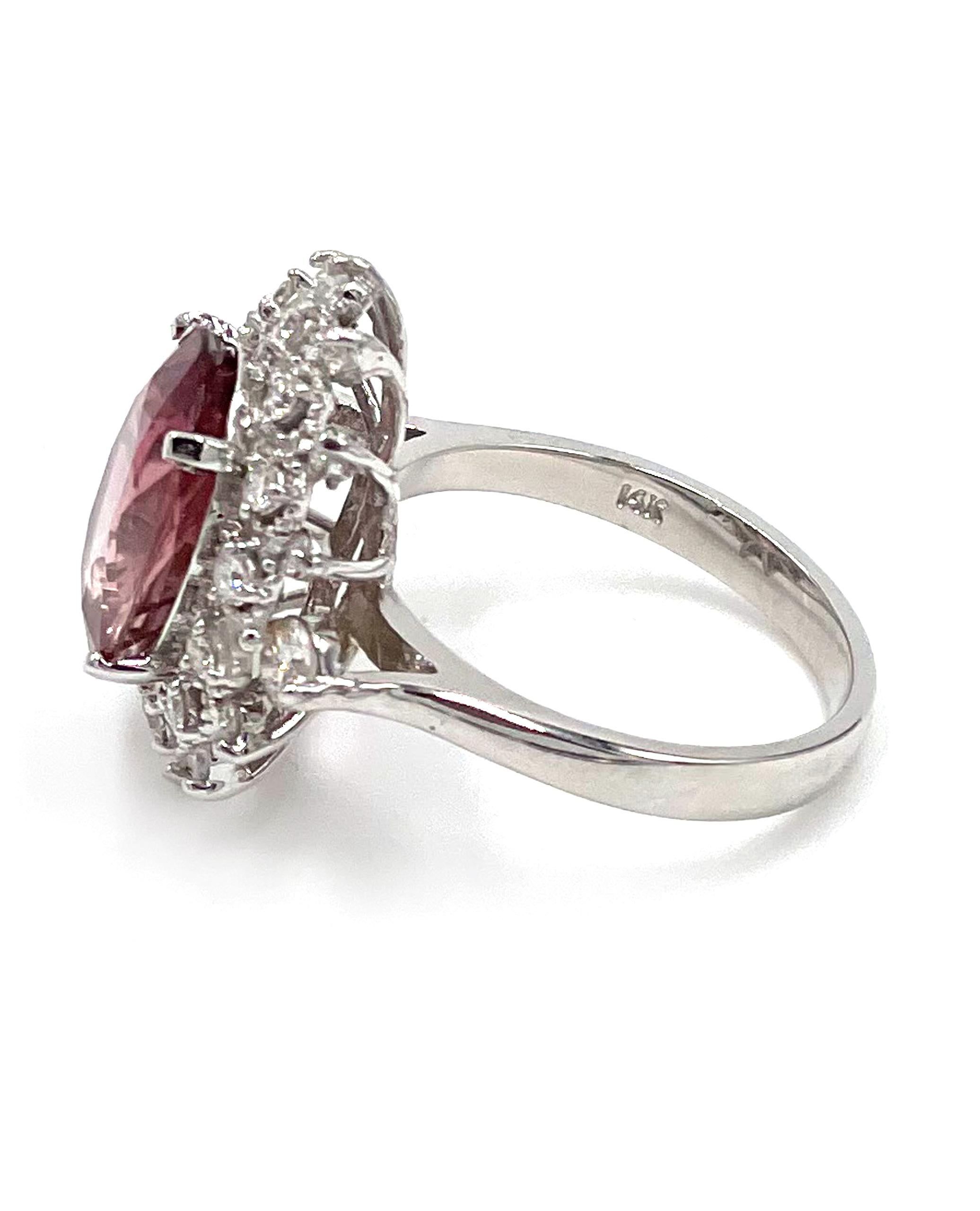 14K white gold classic cocktail ring furnished with 24 round brilliant-cut diamonds with a total weight of 0.90 carat. The center features a brilliant-cut, oval shape pink tourmaline weighing 4.53 carats.

* Finger size 6.5
* Diamonds are F/G color,