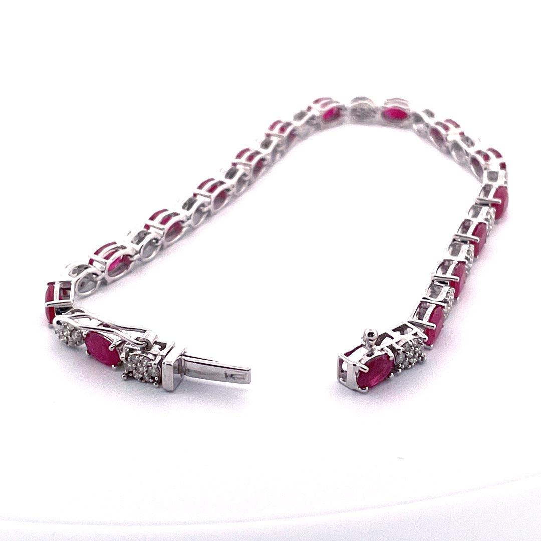 Add a touch of elegance and luxury to your jewelry collection with this stunning 14k white gold bracelet. Weighing 12 grams,
this bracelet features a total carat weight of 1.10 TCW diamonds and 7.71 TCW rubies, making it a truly breathtaking