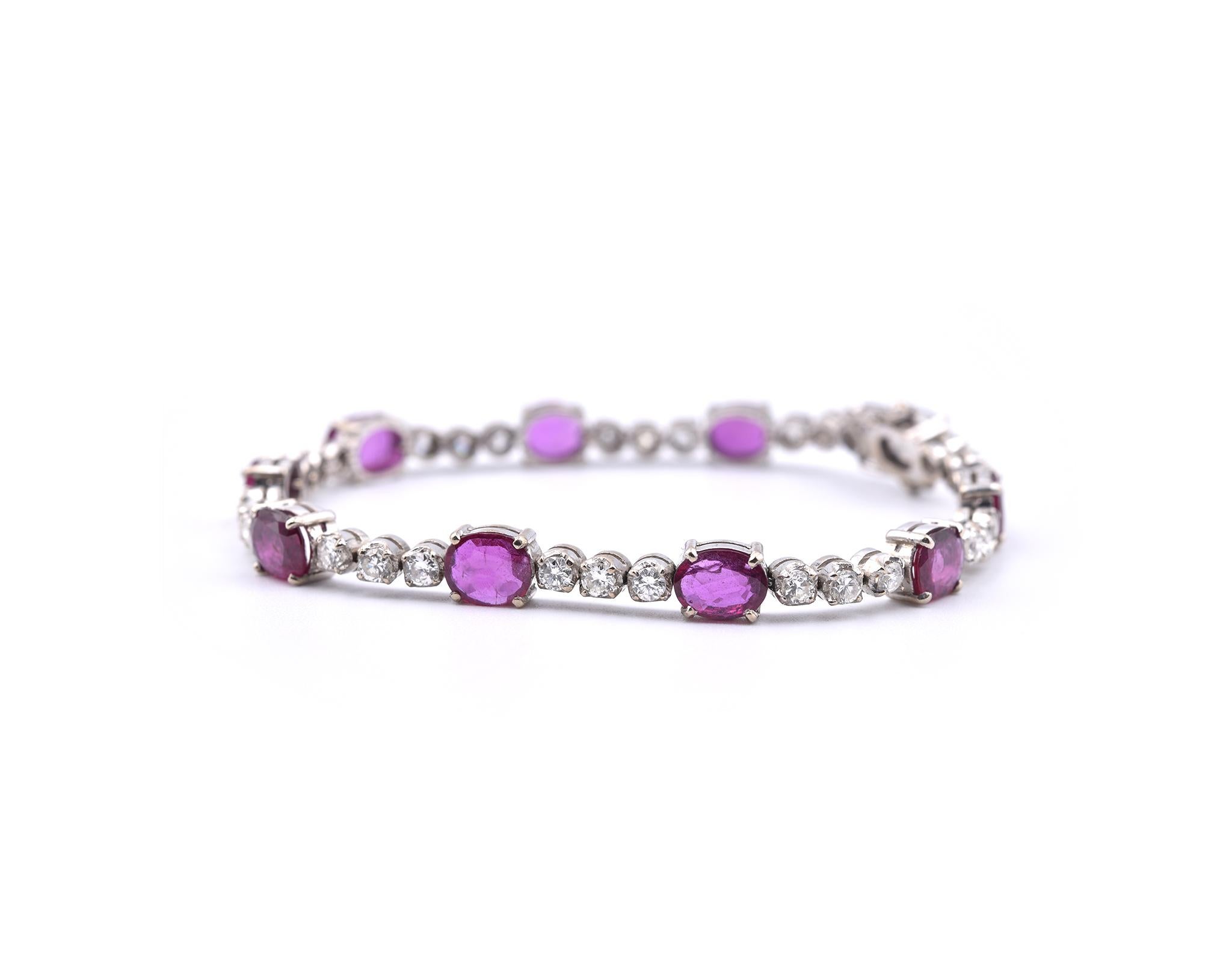 Designer: custom design
Material: 14k white gold
Diamonds: 30 round brilliant cut = 2.10cttw
Color: G
Clarity: VS
Ruby: 10 oval cut = 8.00cttw 
Dimensions: bracelet is 7 inches long and it is 13.62mm wide
Weight: 14.49 grams