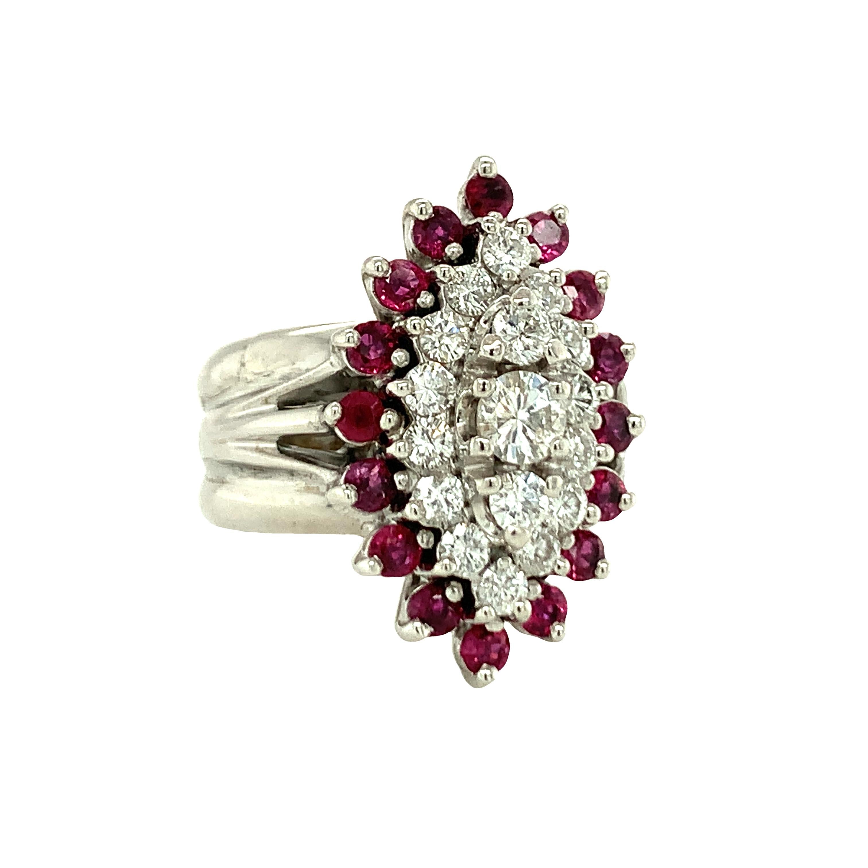 One 14K white gold marquise shaped diamond and ruby cluster ring featuring 17 round brilliant cut diamonds totaling 0.94 ct. with I-J color and SI-2 clarity.  Also featuring 16 round brilliant cut rubies totaling 0.64 ct. Measures 25 mm. long across
