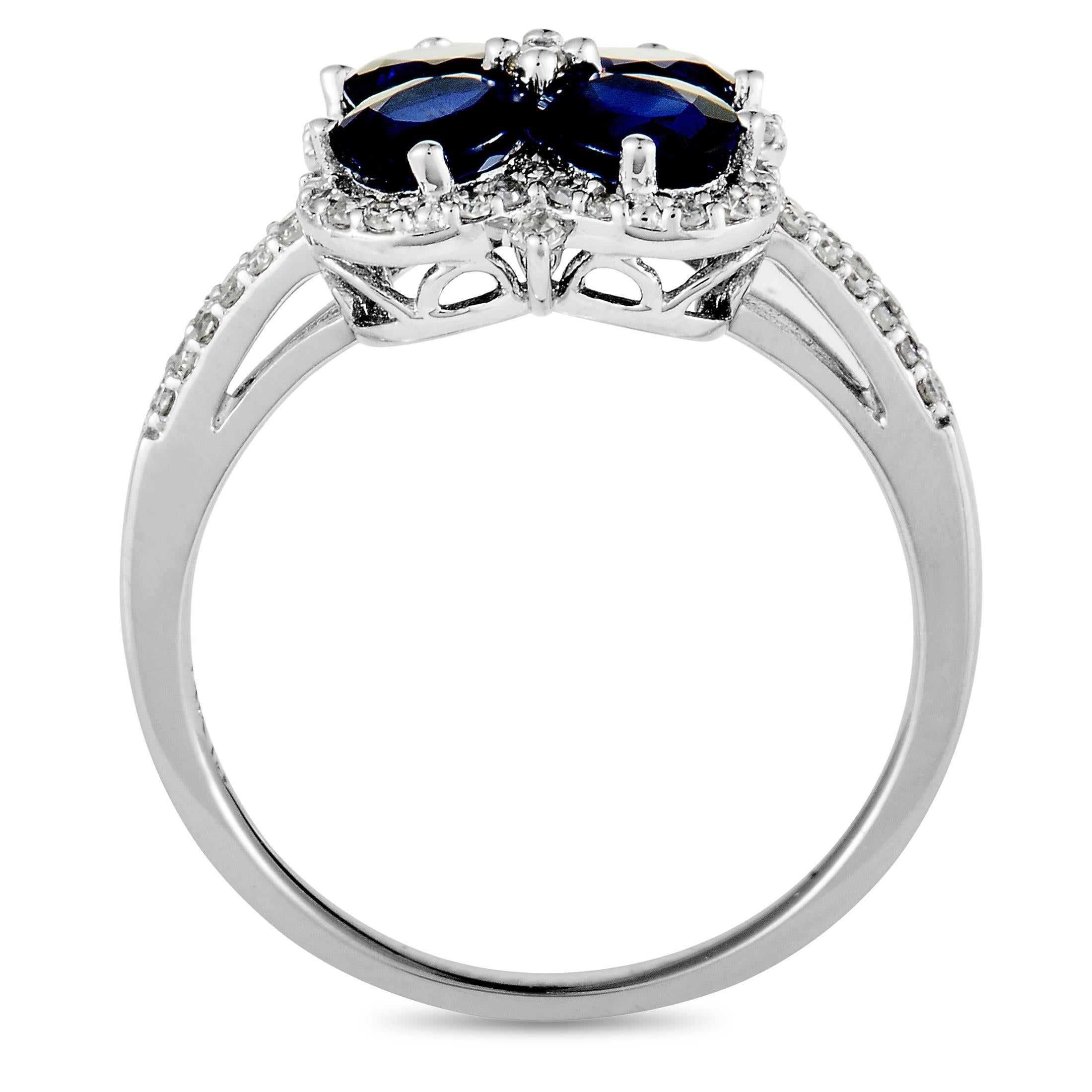 This ring is made of 14K white gold and weighs 3.8 grams. It is set with sapphires and with a total of 0.25 carats of diamonds. The ring boasts band thickness of 2 mm and top height of 6 mm, while top dimensions measure 19 by 11 mm.
 
 Offered in