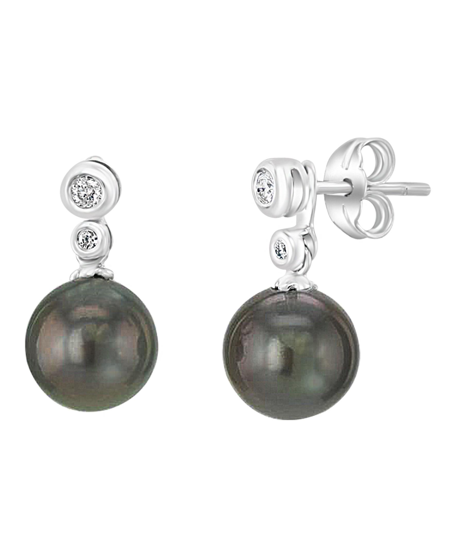 These elegant Diamond and Pearl earrings contain lustrous South Sea Tahitian dark gray round cultured pearls with a green tint to them. The Pearls measuring 7-8mm are dangling from two diamonds totaling 0.08 carats set in 14K white gold bezels. The