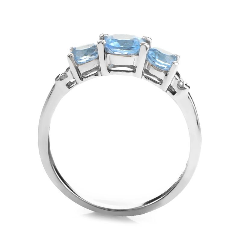 Unabashed charm is exuded with class in this ring setting. 0.03ct diamonds serve as the bookends to a glowing row of three elegant cuts of topaz- all housed in 14K white gold.
