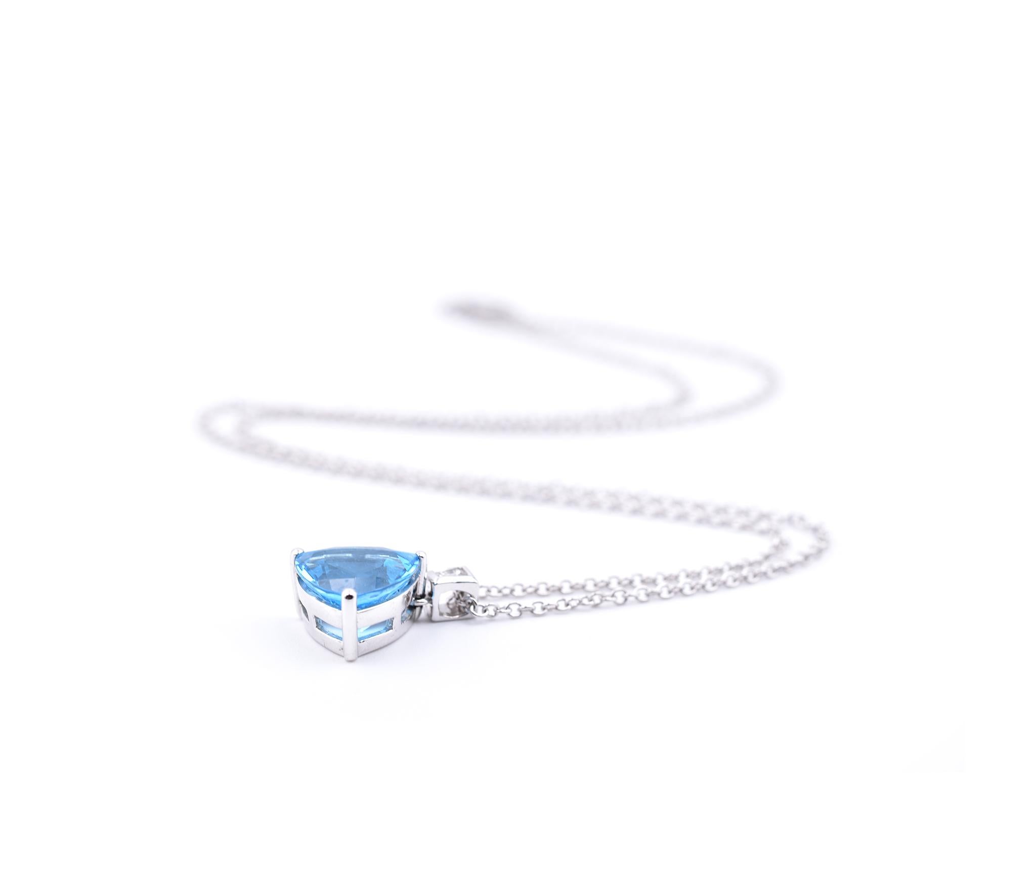 Designer: custom design
Material: 14k white gold
Blue Topaz: one trillion cut= 14.50ct  
Dimensions: necklace is 18-inches long and topaz pendant is ½-inch long and 12.28mm wide
Weight: 2.65 grams
