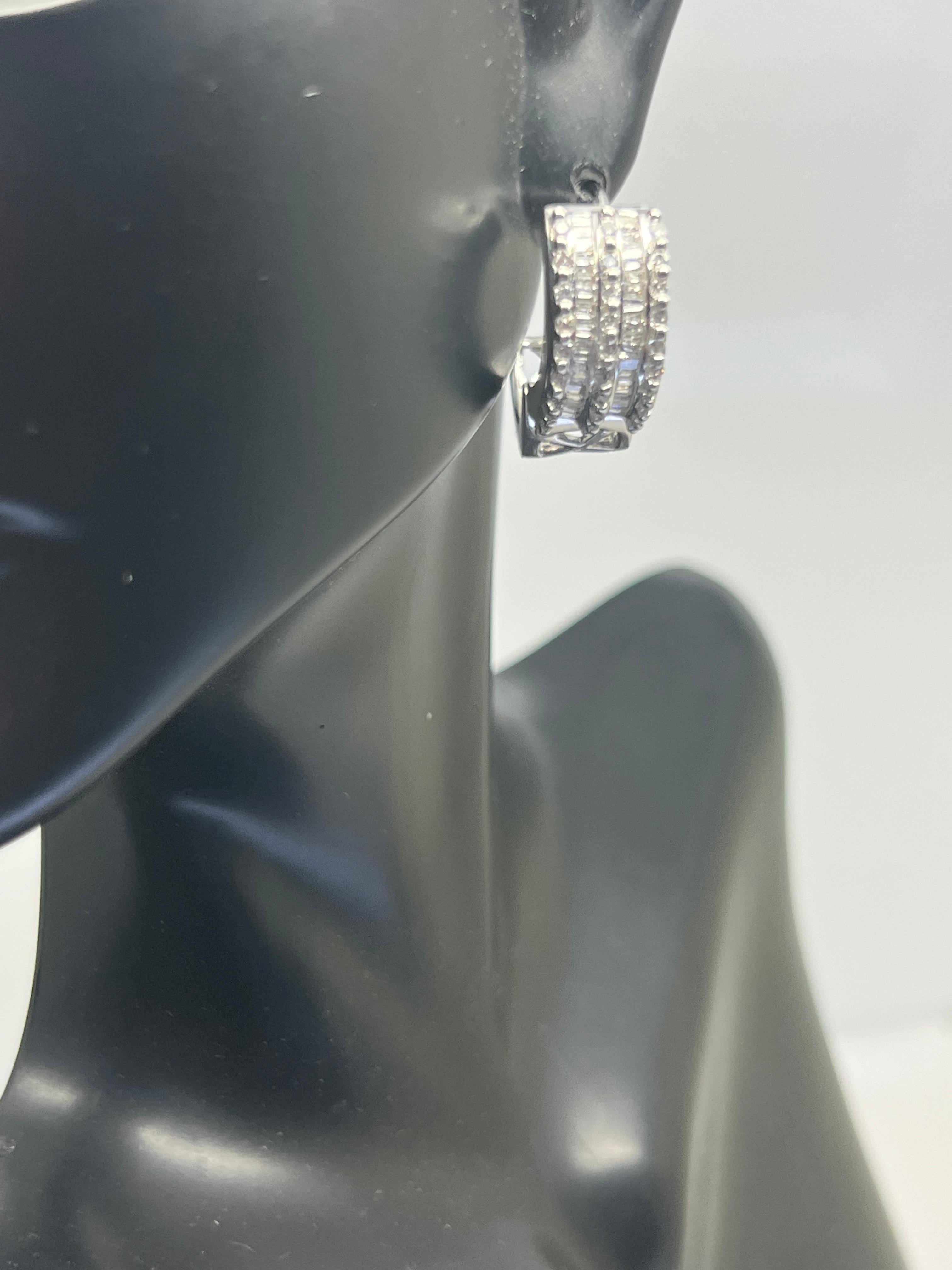 Add a touch of elegance to your jewelry collection with these stunning 14k white gold diamond baguette huggie dangle earrings. Crafted with precision and attention to detail, these earrings boast a channel set design that highlights the brilliance