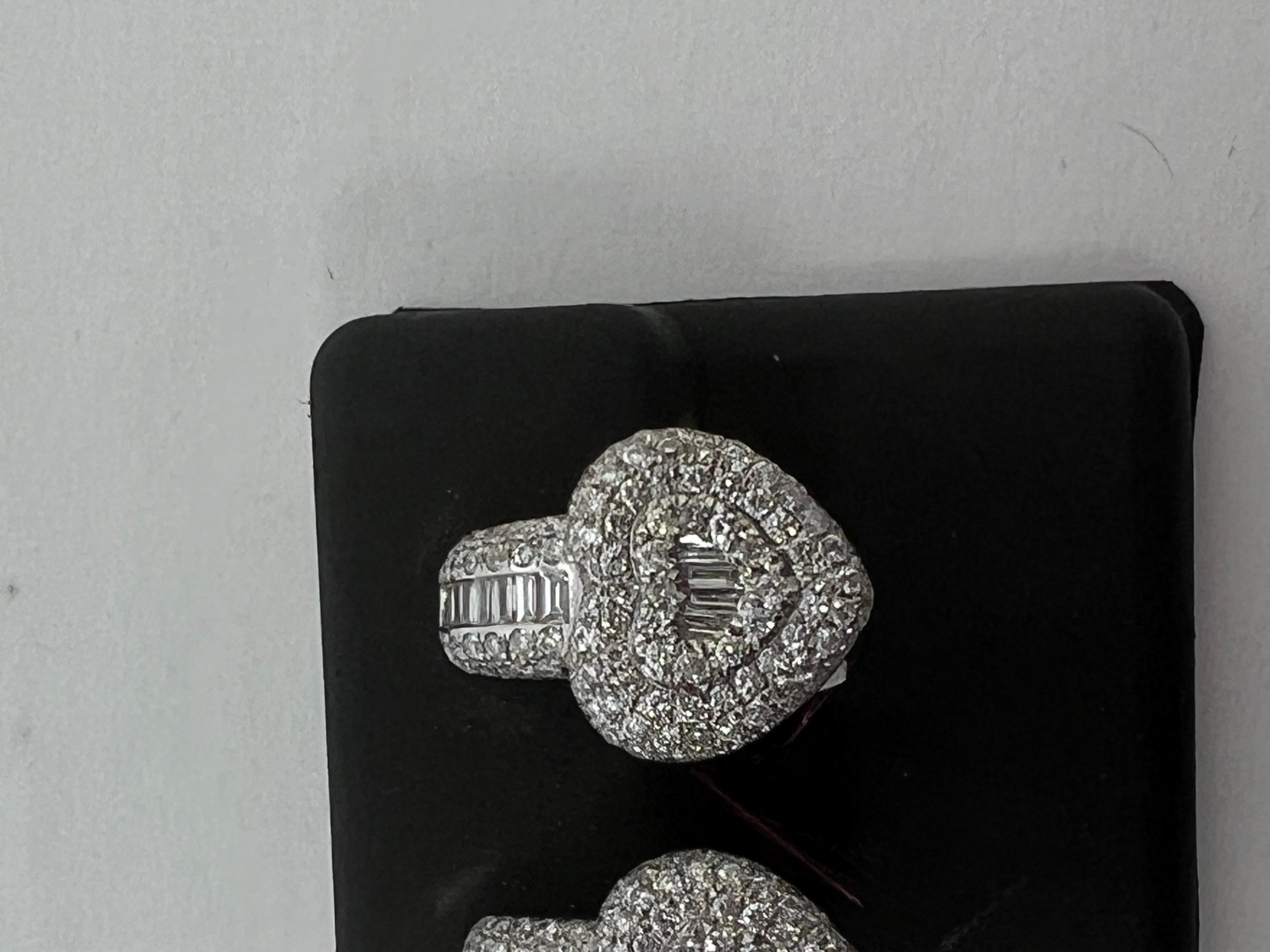 
Elevate your style with these exquisite 14k white gold dangle earrings that feature a stunning combination of baguette and round diamonds. The elegant design of these earrings makes them a perfect accessory for any occasion. The diamonds are