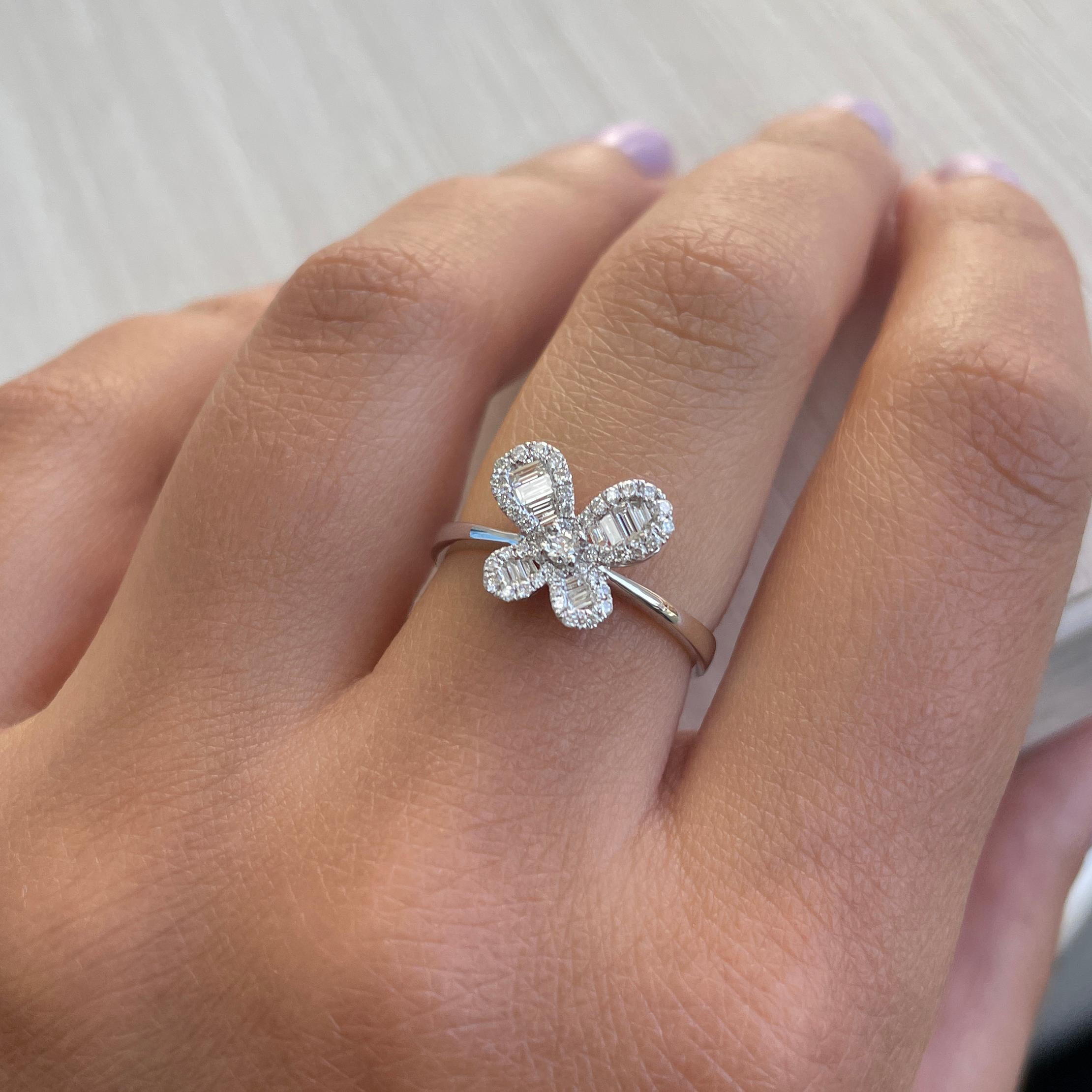 This Delightful Butterfly Ring is crafted of 14K White Gold and features approximately 0.22 cts of Round Diamonds and 0.12cts of Baguette Diamonds, Diamond Color & Clarity is GH-SI1. This ring can be sized by a jeweler one size up or down.
 
 14K