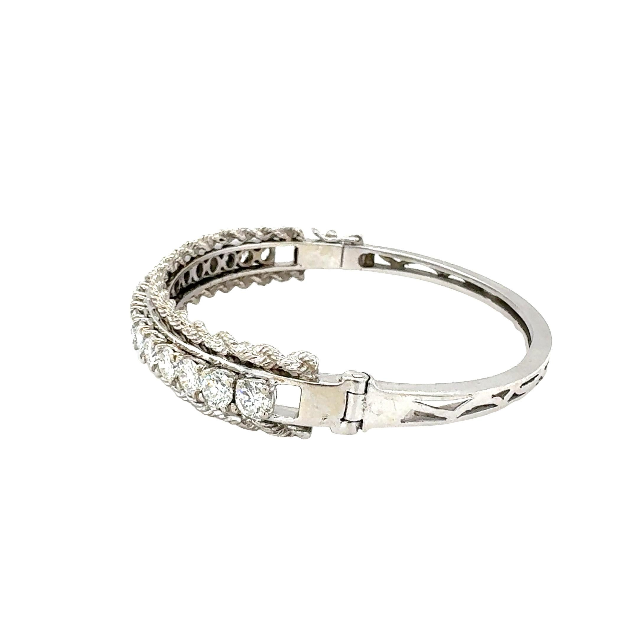 One diamond bangle bracelet in 14K white gold featuring 17 prong set, round brilliant cut diamonds with an approximate total weight of 4.54 ct. with G-H color and VS-2, SI-1 clarity. With twisted rope chain border, measuring 9.8 millimeters wide at