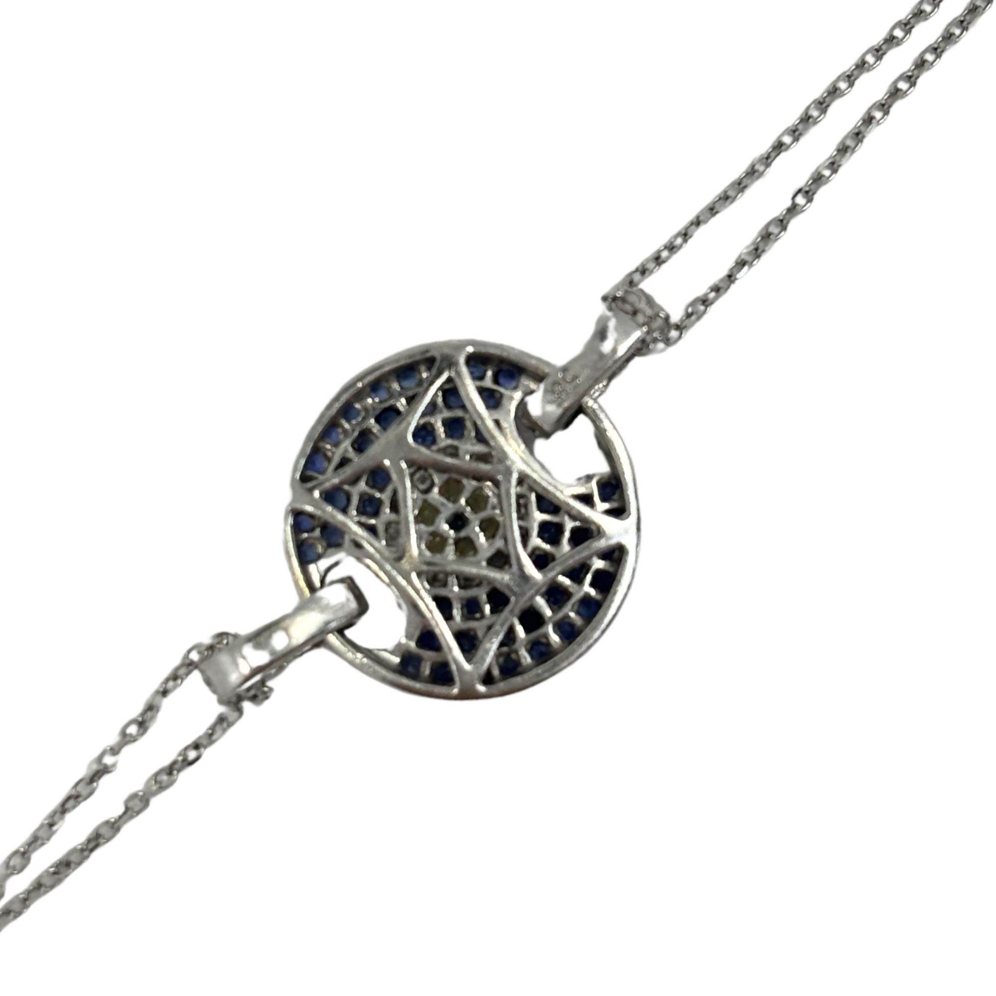 This 14K white gold evil eye bracelet features 0.13 carats of diamonds, 0.56 carats of blue sapphires, and 0.06 carats of yellow sapphires in a bold and vibrant design. Weighing 3.80 grams and measuring 6.5 inches in length, it’s a lightweight,