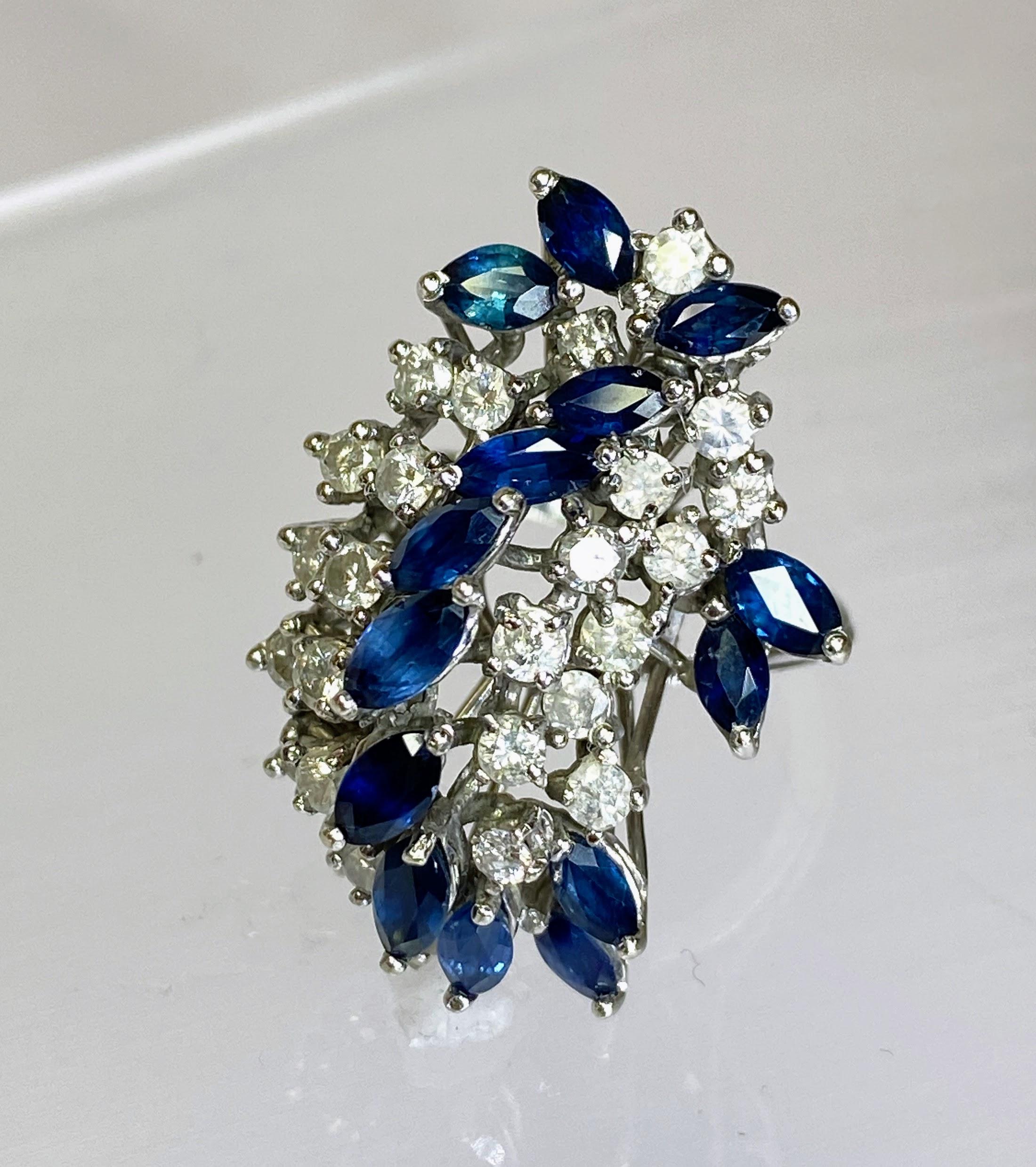 Our 14K White Gold Diamond & Blue Sapphire Waterfall Cluster Ring is a breathtaking piece of jewelry that captivates with its elegance and allure. Crafted from lustrous 14K white gold, this ring boasts a design reminiscent of a cascading waterfall,