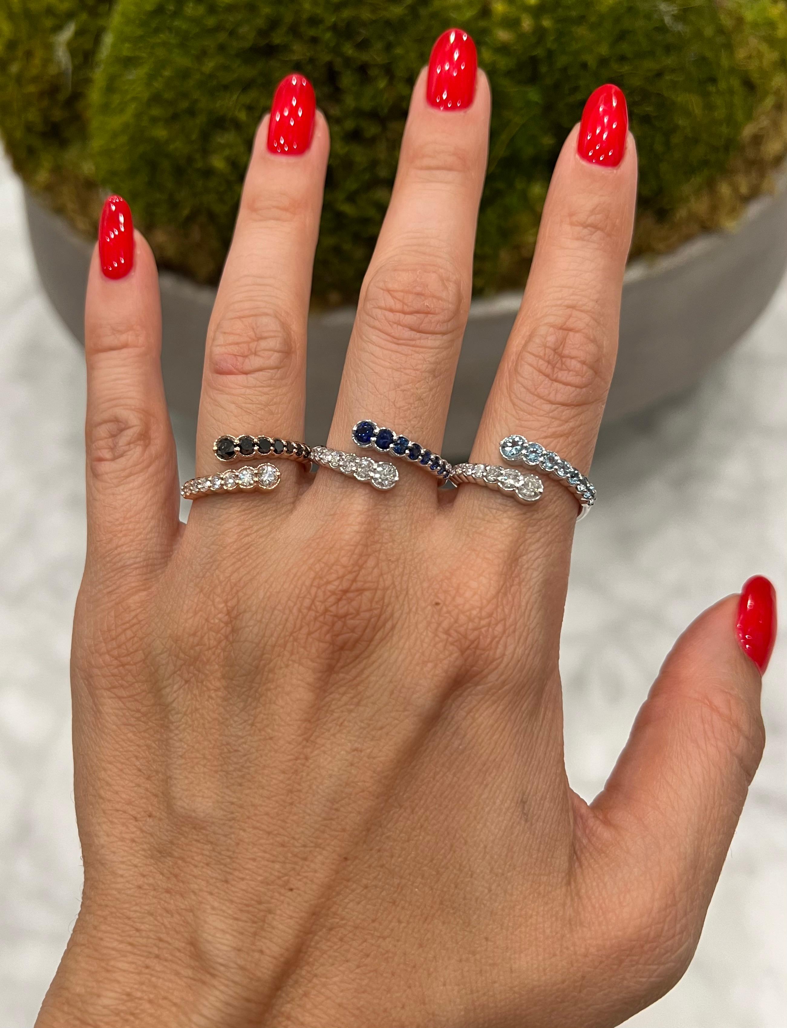 Crafted in 14K gold this ring features clean and contemporary lines. This modern and stylish open bypass ring is set with mesmerizing round-cut 
diamonds and genuine blue sapphire. Stack it with your stacking rings or wear it solo to elevate any