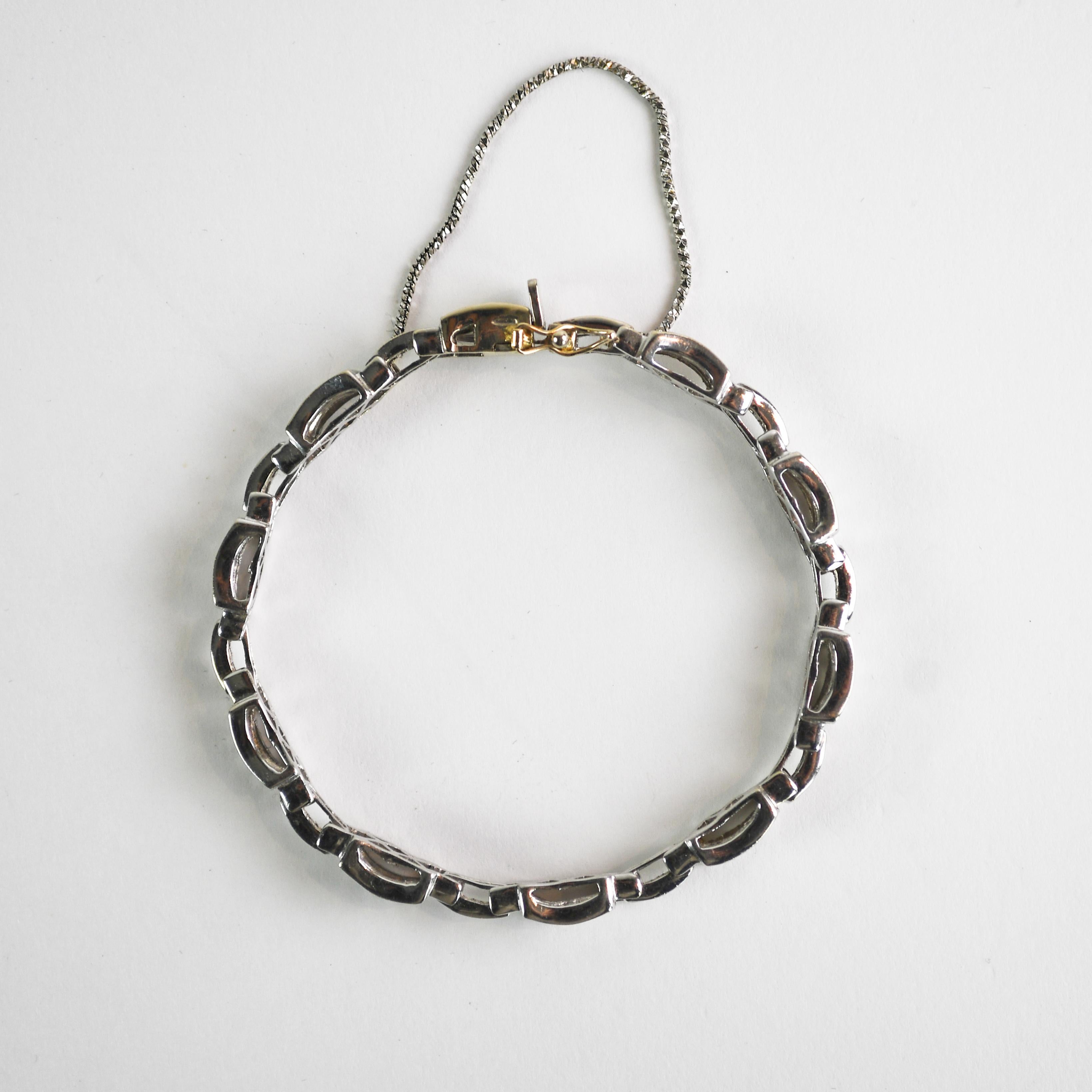 14k white gold diamond bracelet.
Tests 58% gold using an XRF metals analyzer.
Weighs 22.3 grams gross weight.
The diamonds are invisible set, princess cuts, 5.50 total carats, H to I color, Vs to Si clarity.
The bracelet measures 7 inches long and