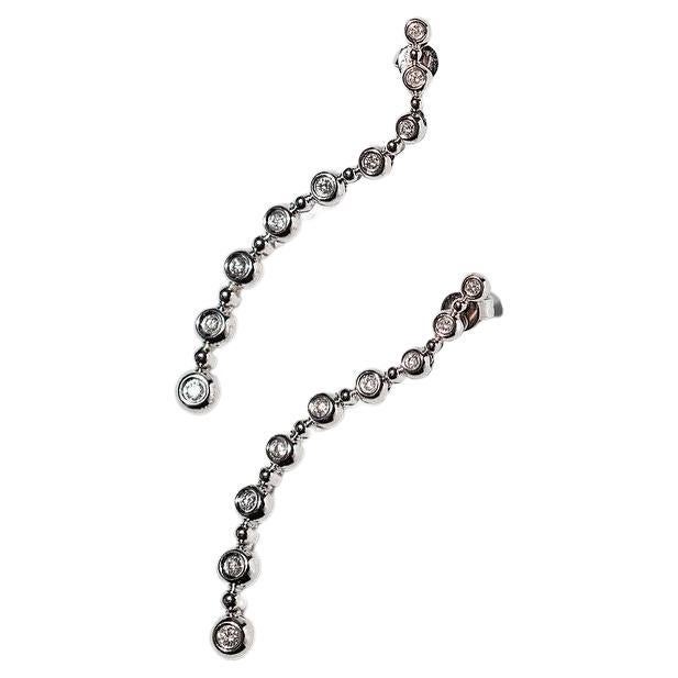 Diamond and White Gold drop earrings bezel set - 14k (vintage) 

Nine diamonds on each strand fall like a diamond waterfall. 
The diamonds are round with a G Colour rating. The earrings are bezel set. 
This style is back in fashion and can be seen