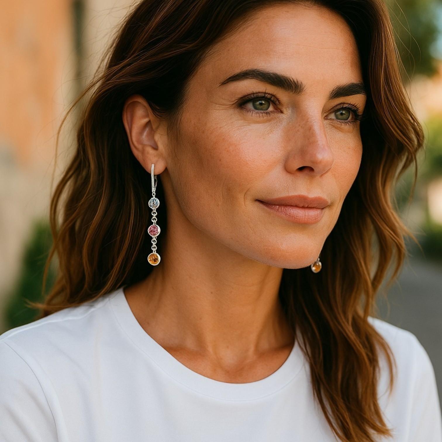 A Luminous Display of Rare Sri Lankan Gemstones
Capture the magic of nature’s most vibrant hues with these 14K White Gold Diamond Drop Earrings, showcasing multi-color Ceylon sapphires and brilliant diamonds. Each lever-back hoop descends into a