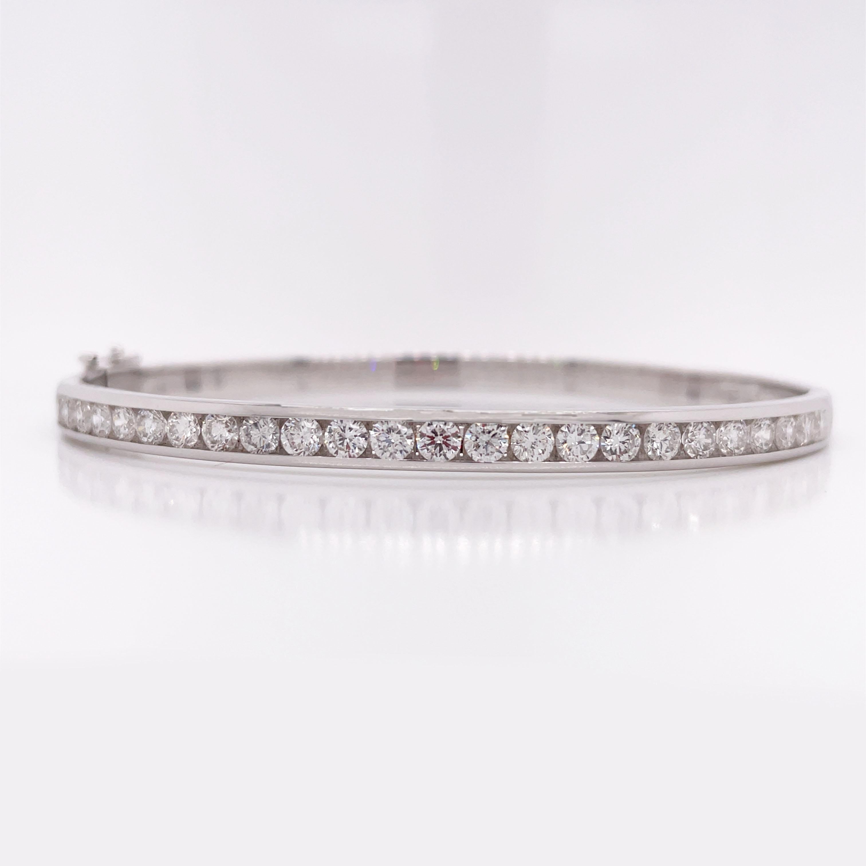 This beautiful bangle is made in 14k white gold and half of the bracelet is channel set with 25 total G/H color Si1 clarity  diamonds. The half diamond design prevents scratches and wear over time, making it perfect for everyday wear. Naturally,