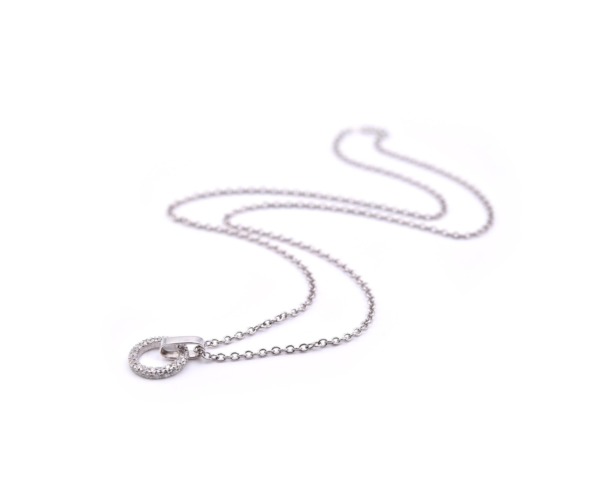 Designer: custom design
Material: 14k white gold
Diamond: 21 round brilliant cut= 0.16cttw
Color: G
Clarity: VS
Dimensions: necklace is 16” inches long, pendant is ½-inch long and it has a diameter 10.63mm
Weight: 3.14 grams