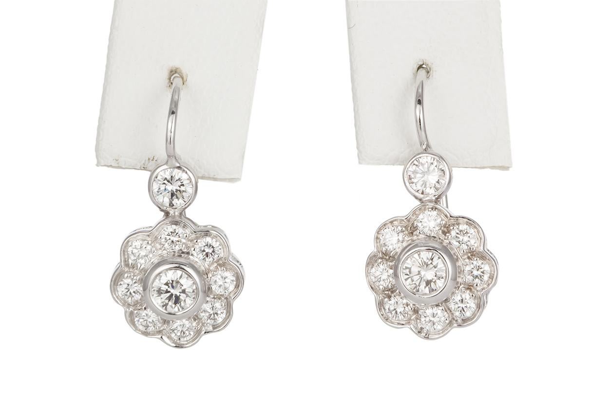 We are pleased to present these 14K White Gold & Diamond Cluster Dangle Drop Earrings. These beautiful earrings feature a clustered dangle drop design with an estimated 1.60ctw H-I/SI1-SI2 Round Brilliant Cut Diamonds set in 14k White Gold. The
