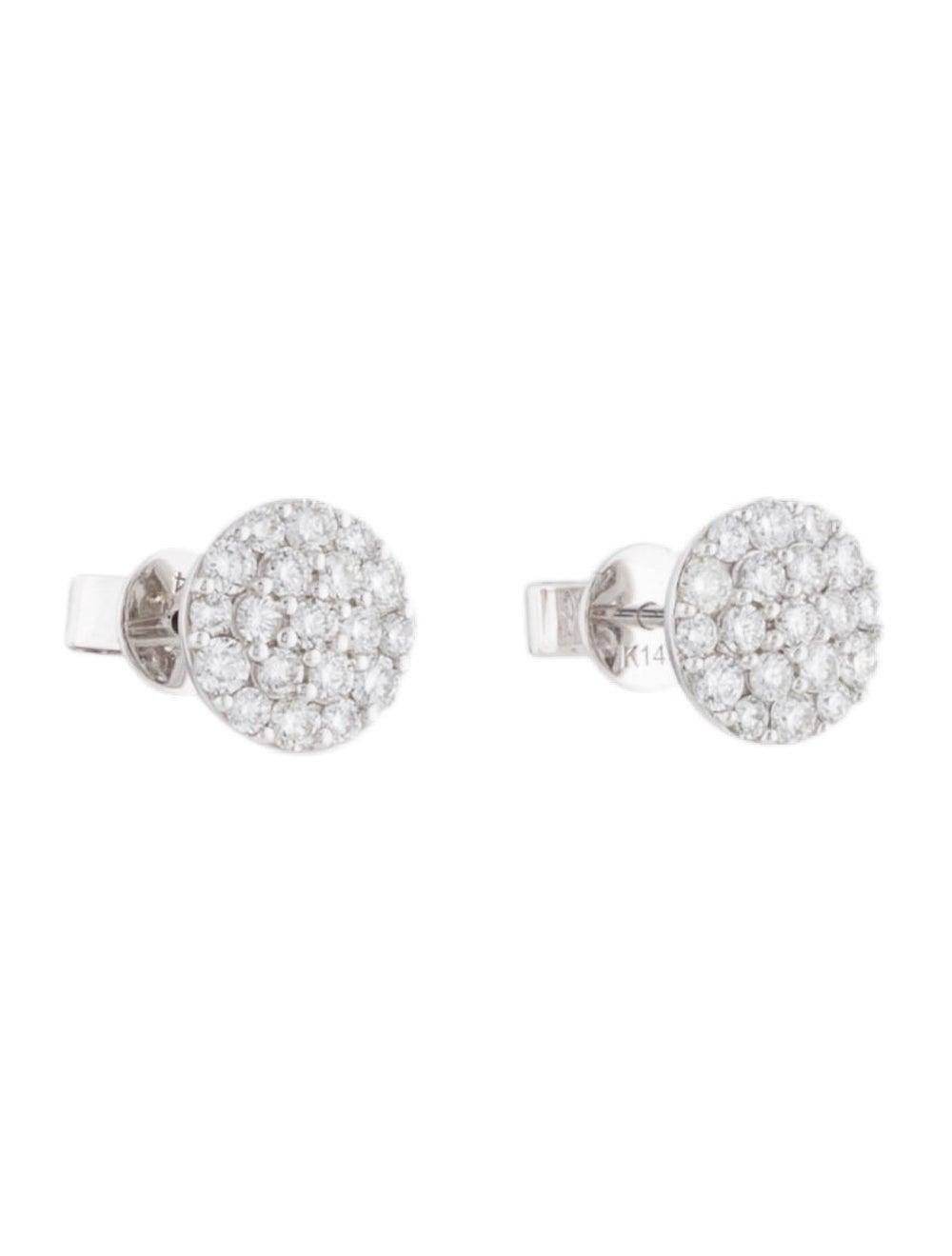 These Beautfiul and Shimmering Diamond Cluster Stud Earrings are crafted of 14K Gold and feature 0.72cts of Round White Diamonds, with butterfly push-back closure.
 
 14K White Gold
 0.72cts White Diamonds
 Shape Round
 Color GH
 Clarity SI1
