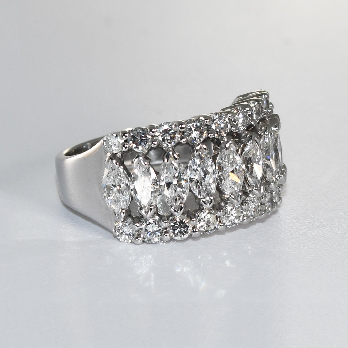 Ladies 14k white gold and diamond cocktail ring.
Weighs 9 grams gross weight.
Tests 57% gold using an XRF metals analyzer.
There are marquise-shaped diamonds in the middle and round brilliant cuts on the sides, G, H, I color range, Vs to Si clarity,
