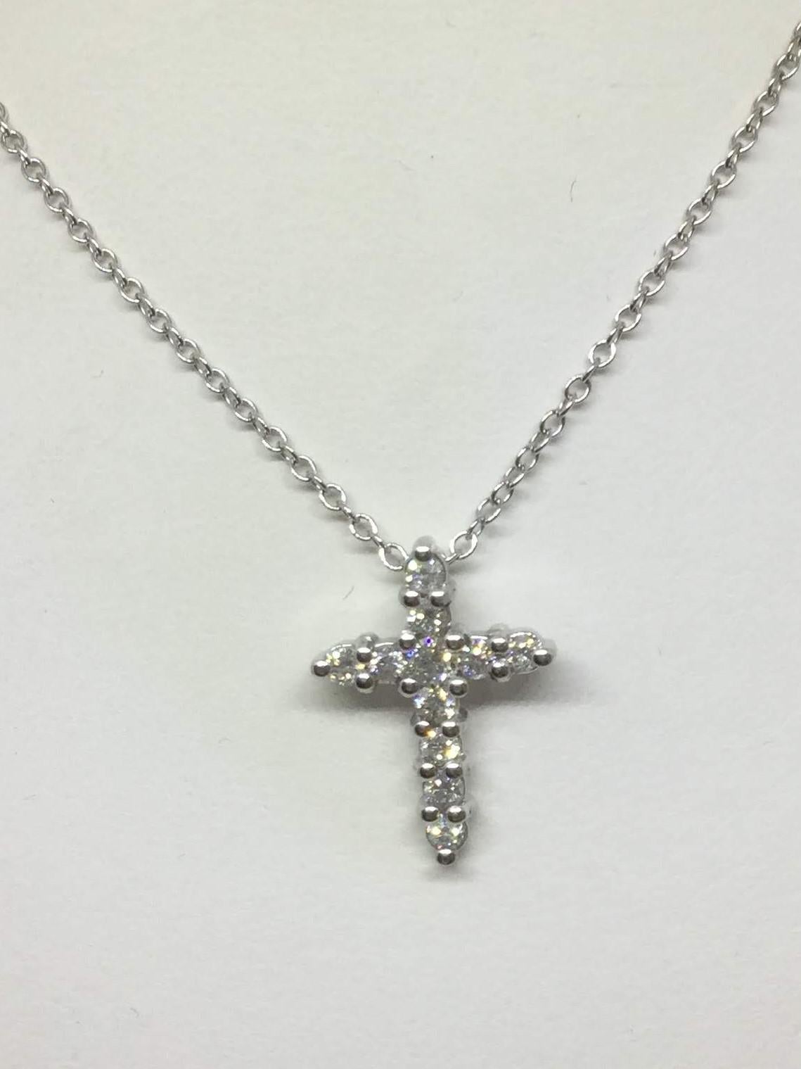 14K White gold diamond cross necklace. The diamonds are round brilliant cut weighing 0.43 ctw H/SI. The diamonds are common prong set. The chain is 16 inches in length.