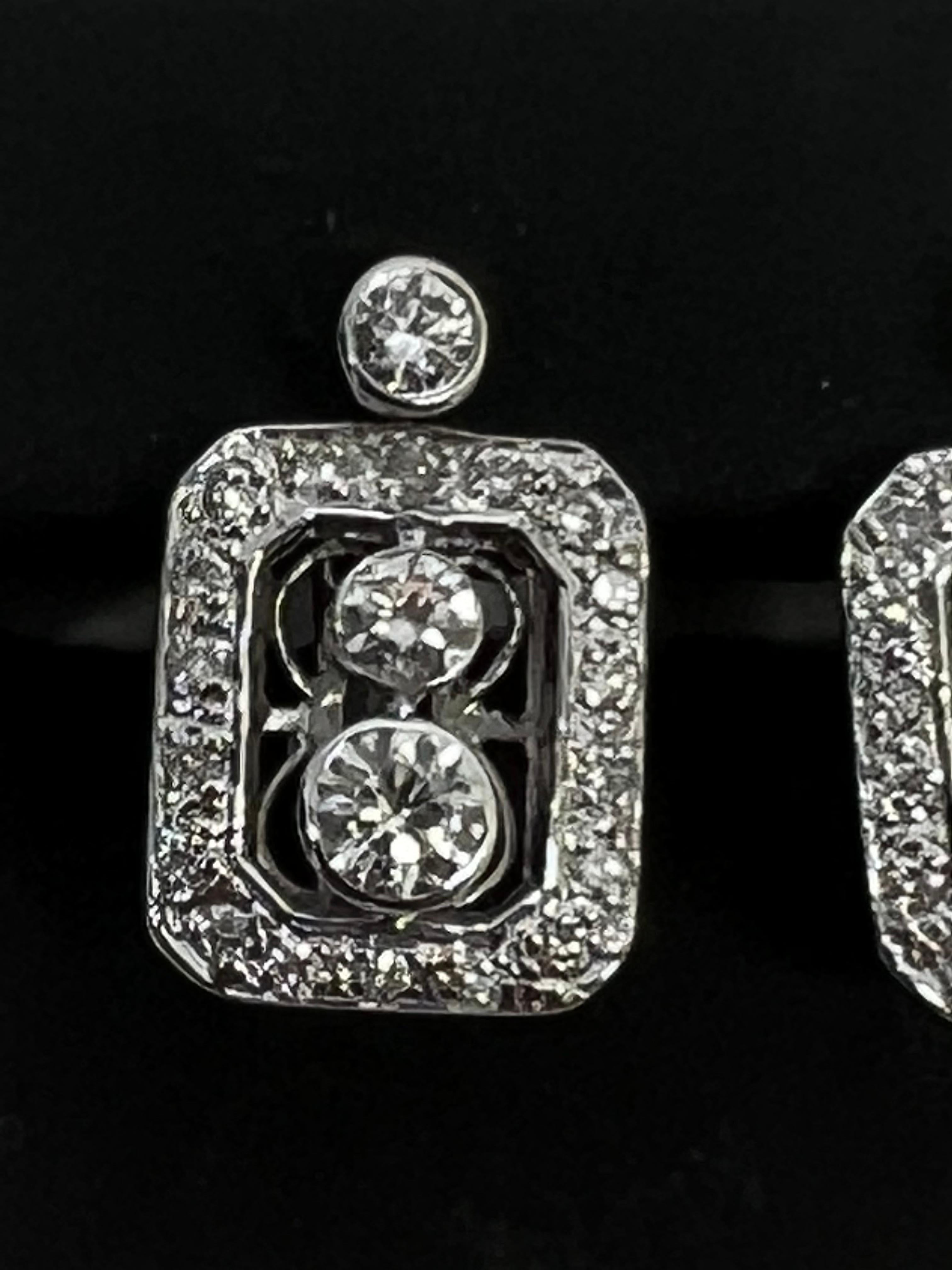 Elevate your jewelry collection with these stunning 14k white gold diamond dangle earrings. The pave setting style with bezel accentuates the natural round-shaped white diamond, creating a breathtaking sparkle that will catch everyone's eye. The