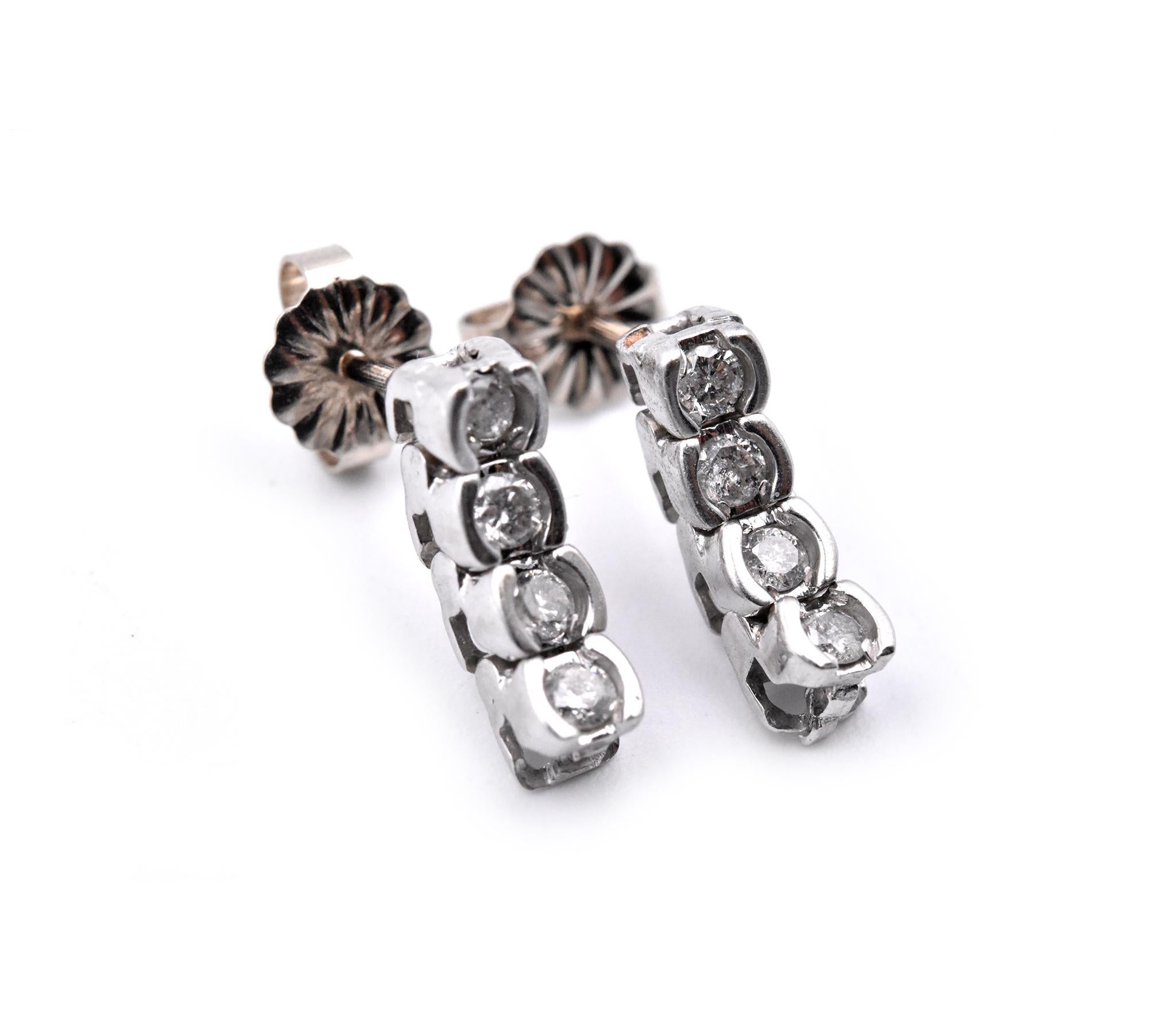 Material: 14k white gold
Diamonds: 8 round brilliant cuts = 0.25cttw
Color: H
Clarity: I1
Dimensions: earrings measure 13mm x 3.67mm
Fastenings: post with friction backs
Weight: 2.1 grams
