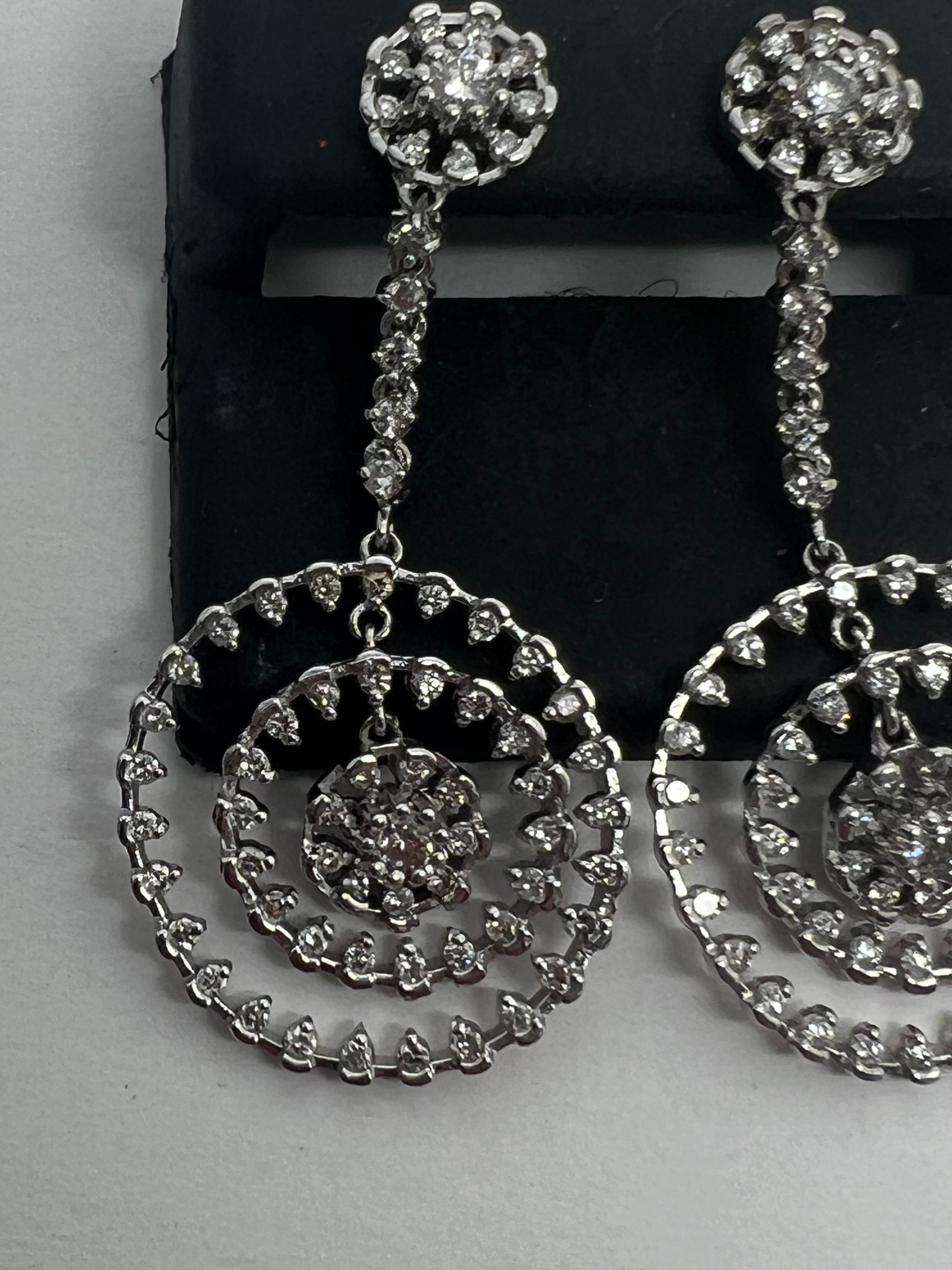Elevate your style with these stunning 14k White Gold Diamond Drop Dangle Circle Pave Earrings. Crafted with exquisite attention to detail, these earrings feature natural round diamonds set in a pavé style, creating a shimmering effect that will