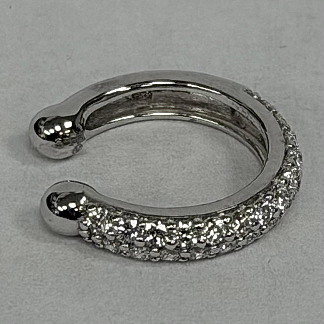 This 14K White Gold Diamond Earring Cuff is a bright and stylish piece that adds a soft sparkle to your look. Made from 1.9 grams of solid white gold, it feels light, smooth, and comfortable to wear all day. The cuff is set with 50 round diamonds