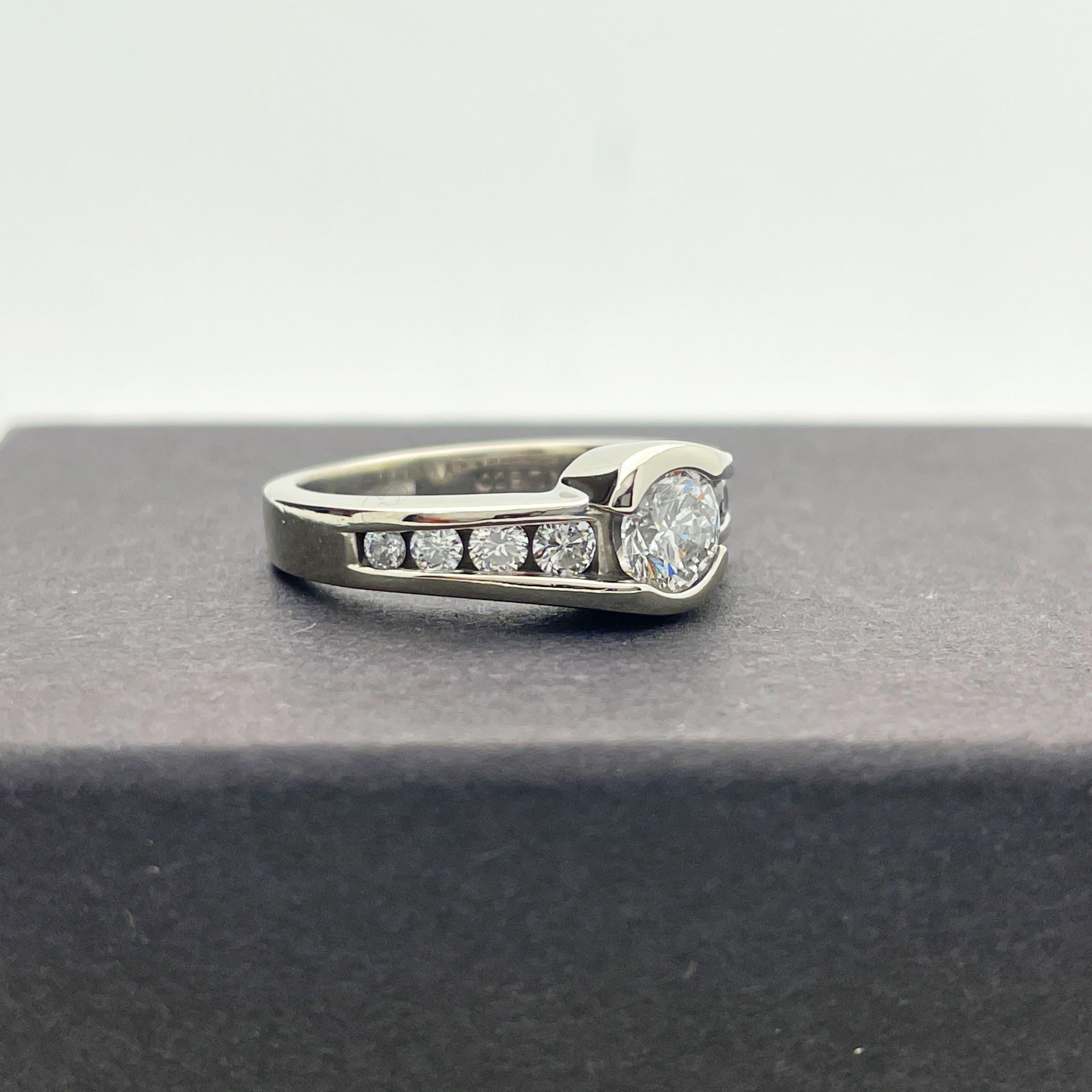 Here is a beautiful 14k White Gold Diamond Engagement Ring.

This ring features a center 0.57ct round brilliant cut diamond measuring 5.30mm x 3.35mm. I-1 clarity grade, G-H colour with good polish, symmetry and proportions. Surrounded by 8x 0.03ct