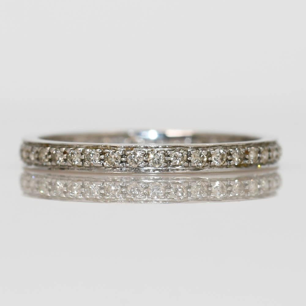 14k white gold diamond eternity ring.
Tests 14k and weighs 1.3 grams.
The diamonds are round brilliant cuts, .50 total carat weight,  J to K color range, Si clarity, good cuts.
The ring measures 2.5mm thick.
Ring size is 8 and can be sized down one