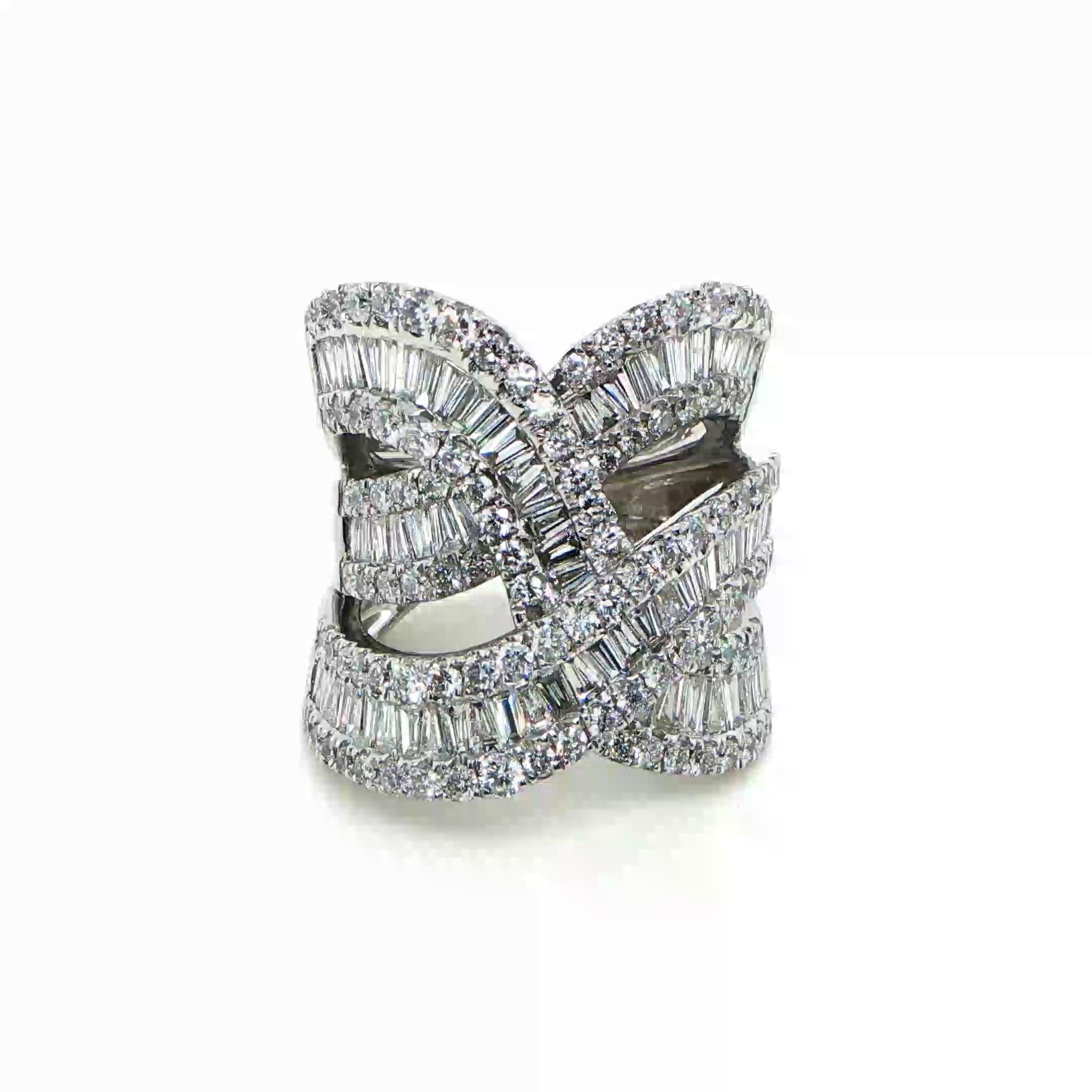This stunning 14 karat white gold fashion ring showcases an extraordinary arrangement of 158 round and baguette-cut diamonds, totaling an impressive 3.00 carats. Designed with an architectural, multi-row pattern, the ring displays a dynamic