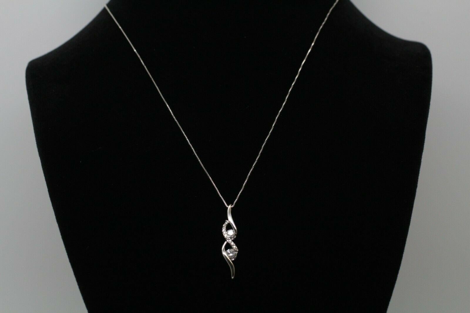 Contemporary 14 Karat White Gold Diamond Figure 8 Pendant