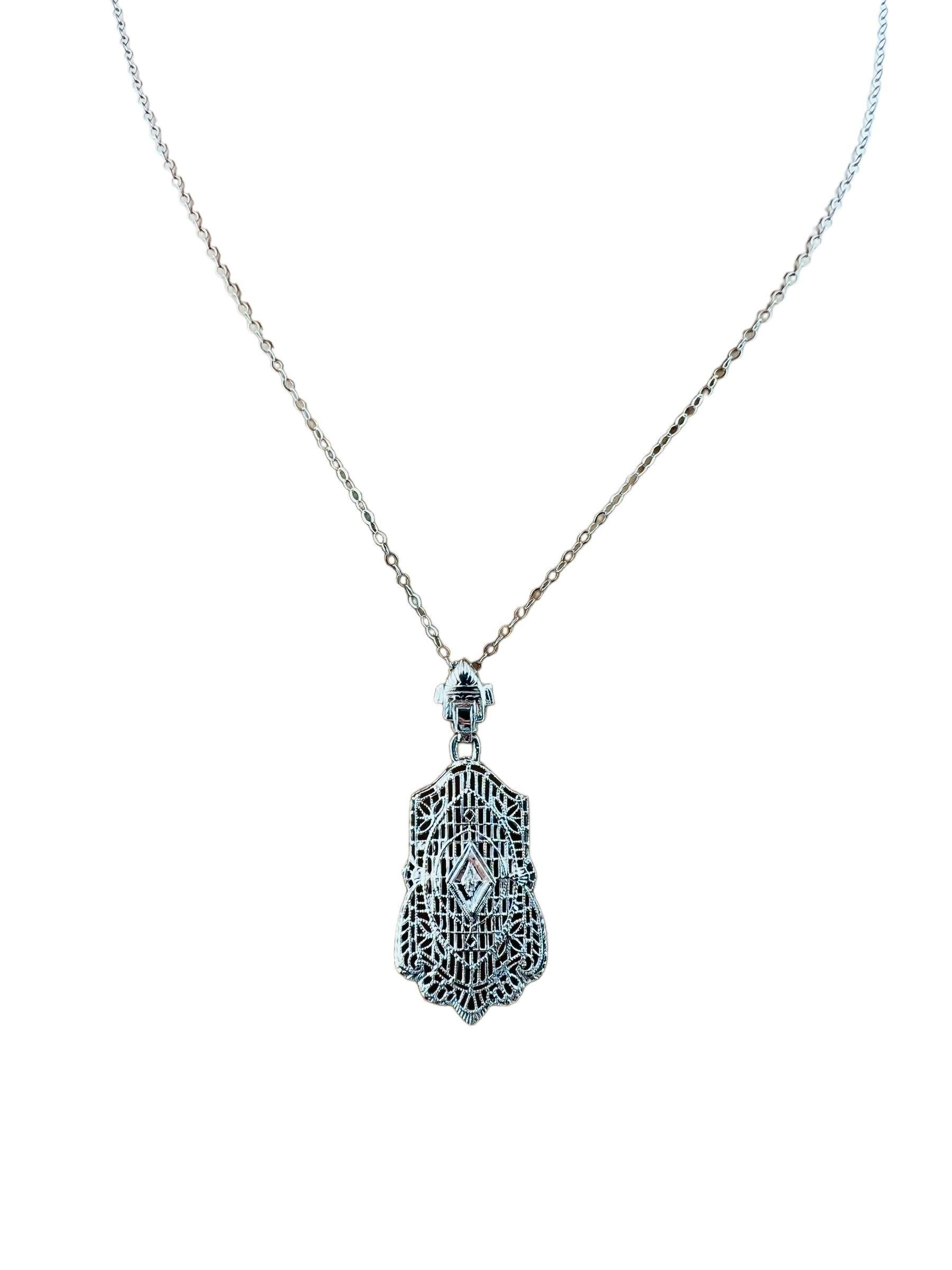 14K White Gold Diamond Filigree Pendant Necklace

This beautiful white gold necklace features a filigree style pendant accented with a center diamond.

Single cut diamond is approx. 0.01 cts

Diamond clarity - I1

Diamond color - J

Chain is approx.