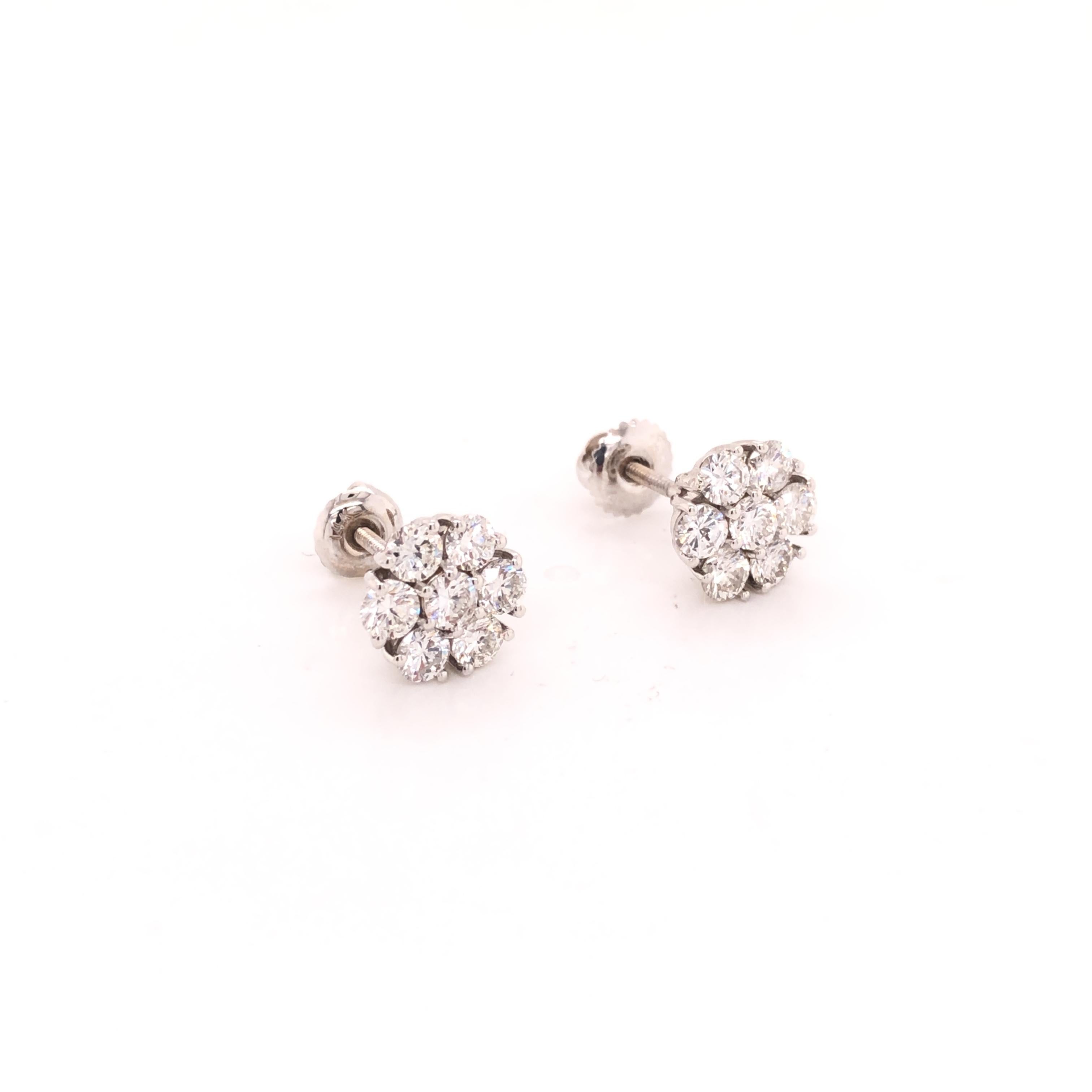 A simple and elegant pair of cluster diamond floral earring studs contain 14 round-cut 10 pointer diamonds, set in 14K white gold.

Diamond weight ~ 1.40 carats