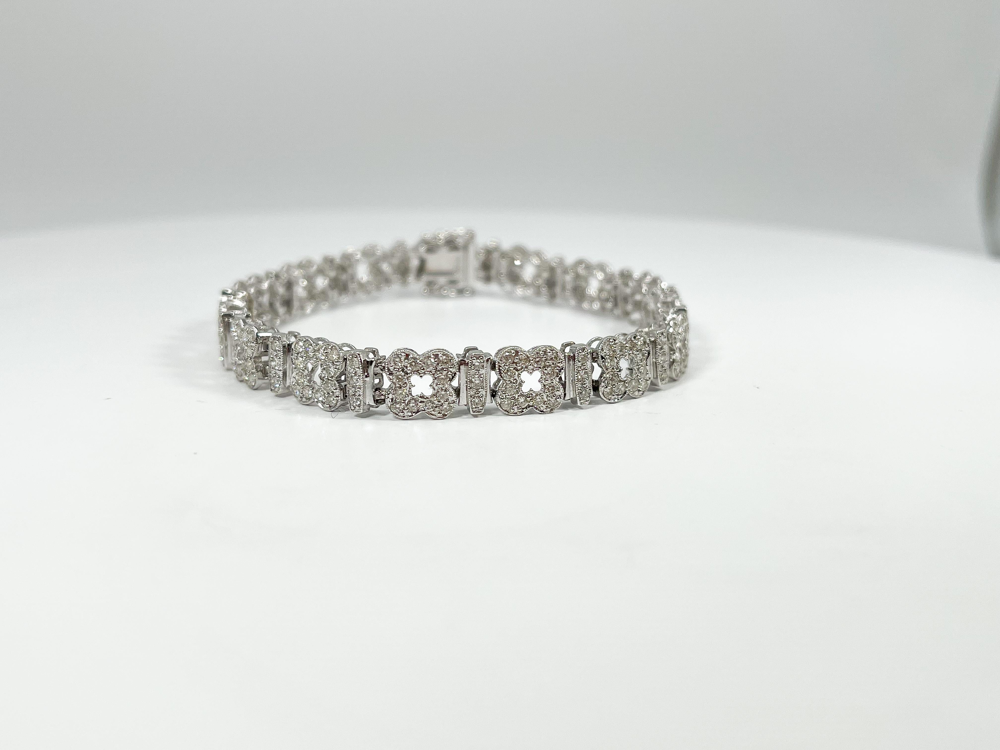 14k white gold diamond flower bracelet 2.50 CTW. All stones are round, bracelet measures 7 inches, and has figure 8 clasps for closure, and the bracelet has a total weight of 15.6 grams.