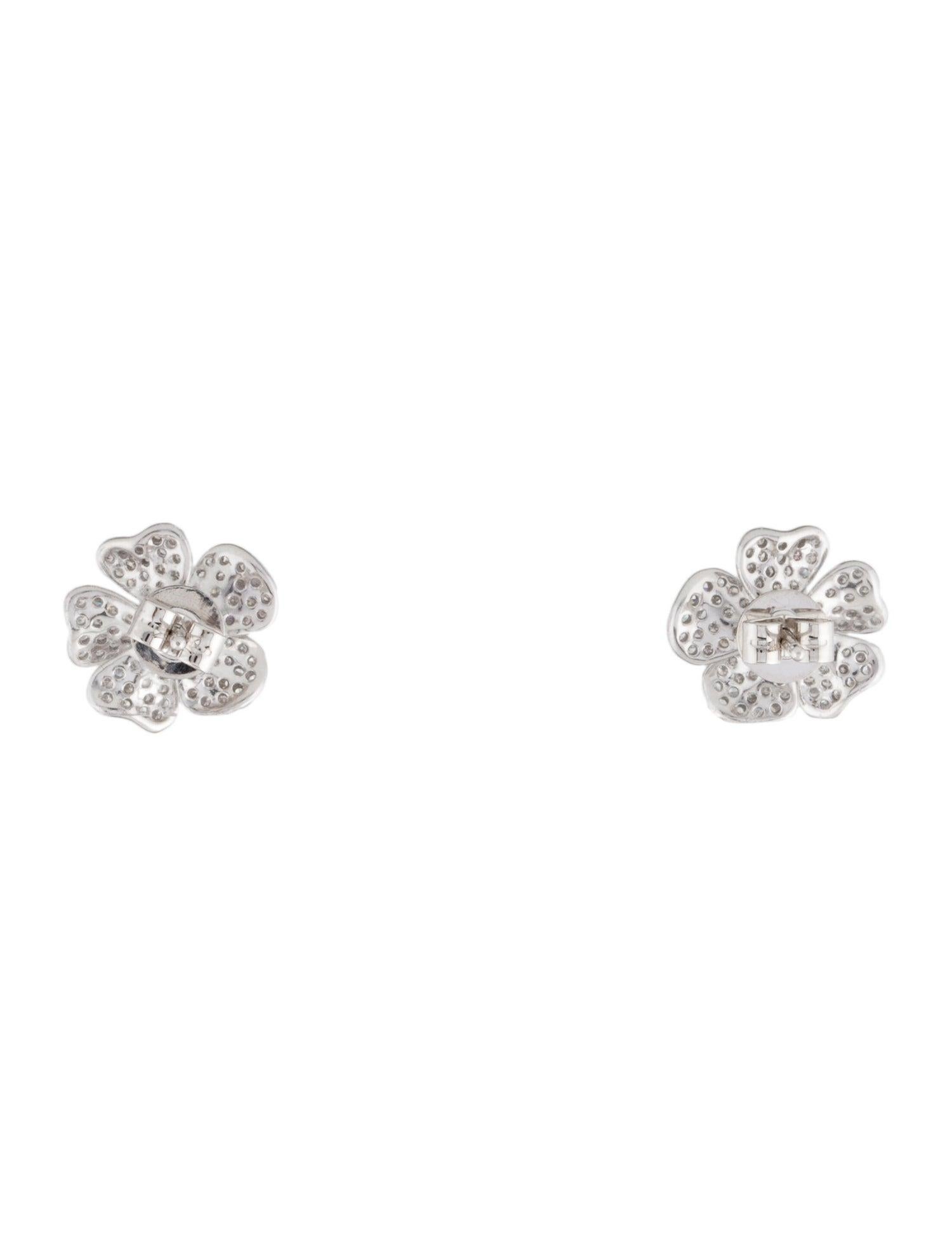 Wonderfully lovely and artfully unique, this set of flower earrings is sure to brighten and cheer your day. Delicate petals drenched in diamonds bring a touch of dazzle to your look. White 14 karat gold makes for a lasting and decadent addition to
