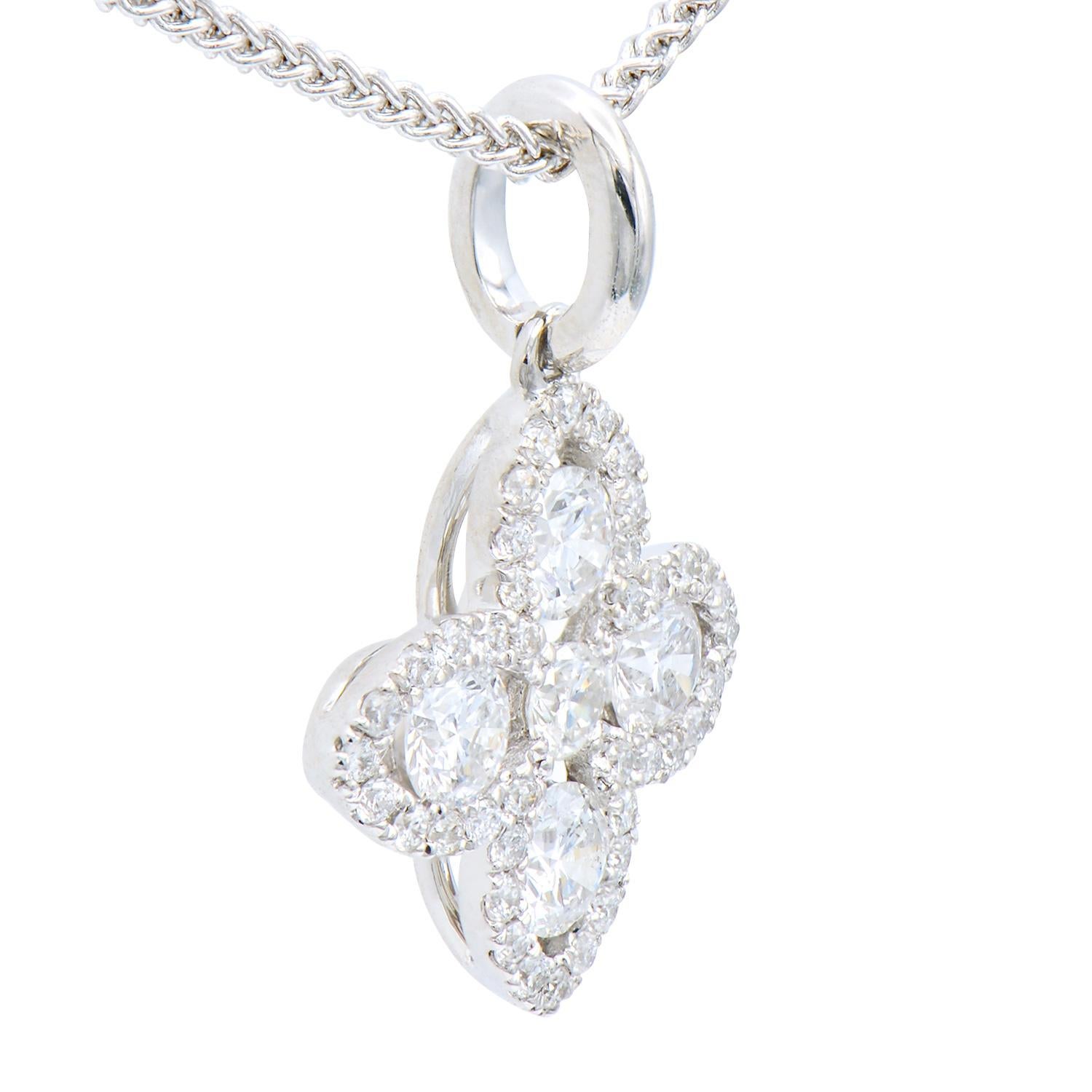 This beautiful pendant is made from 4 white gold diamonds totaling 0.33 carats which are surrounded by 41 round SI, H color diamonds totaling 0.15 carats. Together they form a lovely flower or four-leaf shape that is very classic and timeless. The