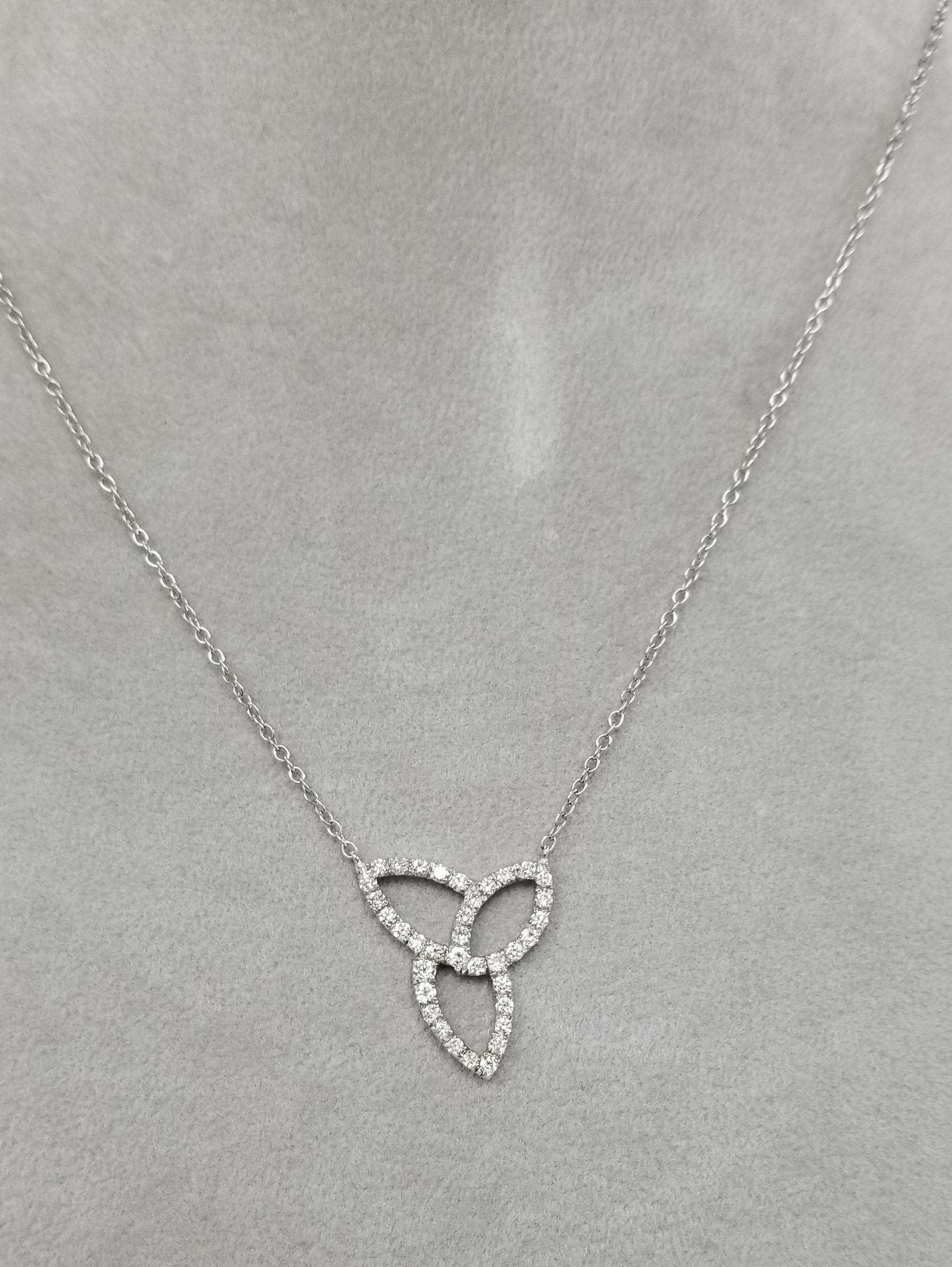 14k white gold diamond free form necklace, containing 40 round full cut diamonds weighing .80pts. on a 18 inch chain.