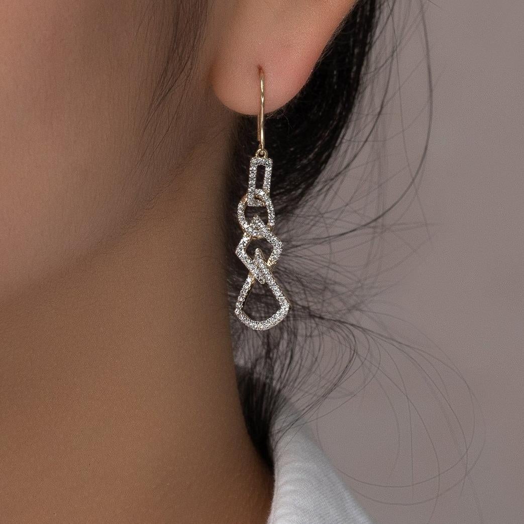 These geo art diamond dangling earrings are stunning. The geometric design delivers an eye catching and eye pleasing look. The diamonds in these dangling earrings give it the final wow factor. These white gold drop earrings can be worn for almost