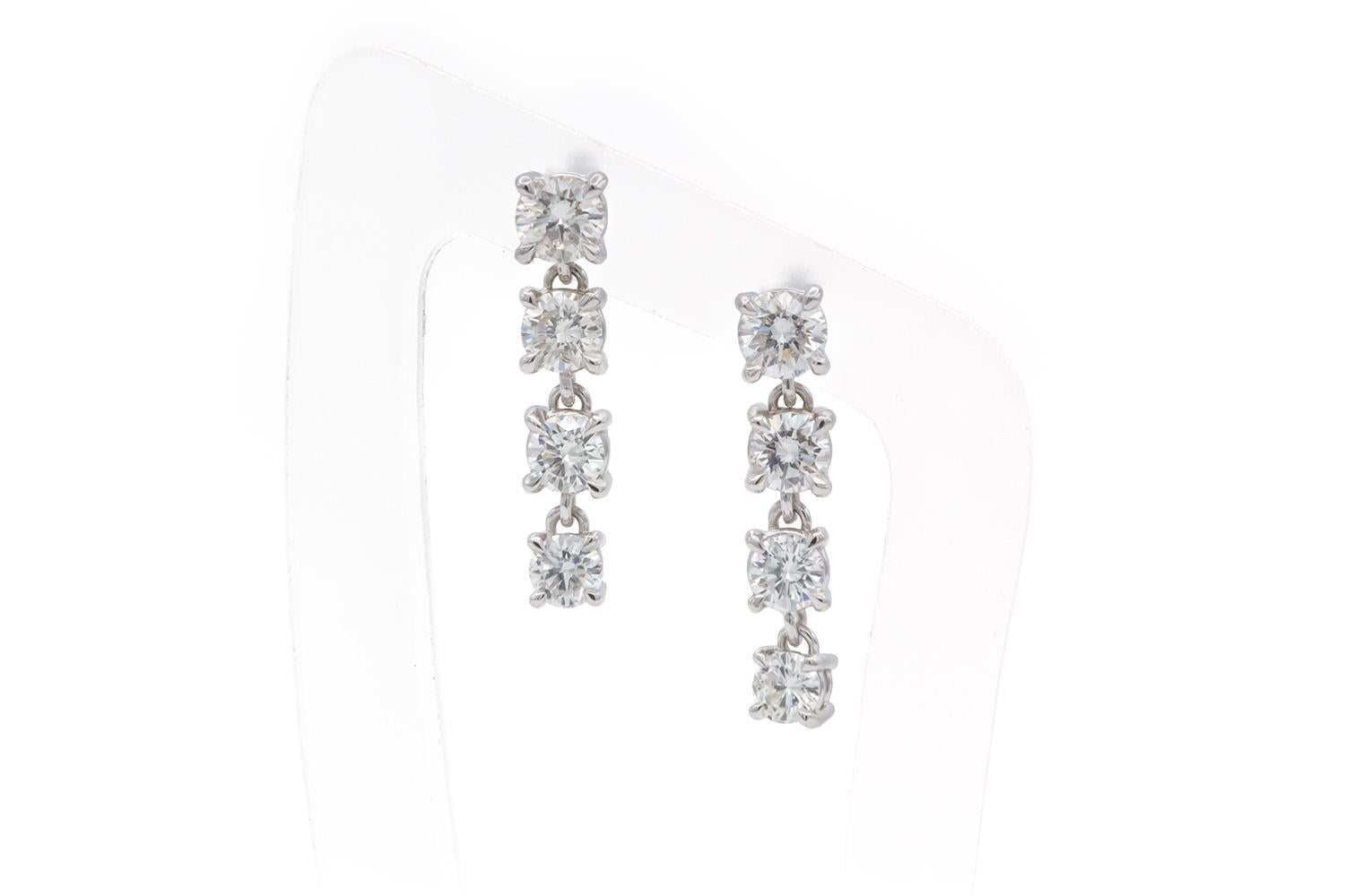 We are pleased to offer these Brand New Unworn 14k White Gold & Diamond Graduated Dangle Drop Earrings. These stunning earrings are fun and vibrant! They feature 0.98ctw G-H/SI1-SI2 round brilliant cut diamonds set in 14k white gold 4 prong dangle