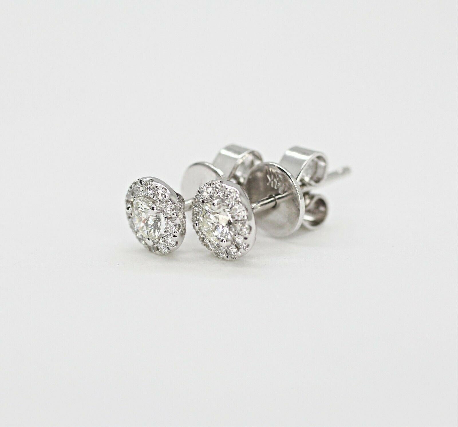  14k white gold diamond halo earrings containing, 
Specifications: .63pts. total weight
    main stone: 2 PCS OF ROUND CUT DIAMONDS 0.51 CTW 
    ADDITIONAL: 24 PCS ROUND 0.12 CTW
    color: G-H
    clarity: VS,SI
    brand: custom
    metal: 14k